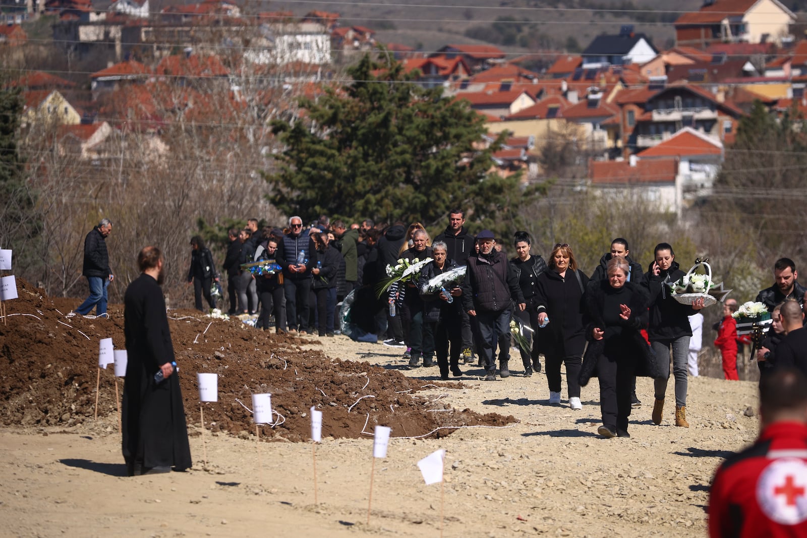 People gather at a cemetery for the funeral ceremony of the victims of a massive nightclub fire in the town of Kocani, North Macedonia, Thursday, March 20, 2025. (AP Photo/Armin Durgut)