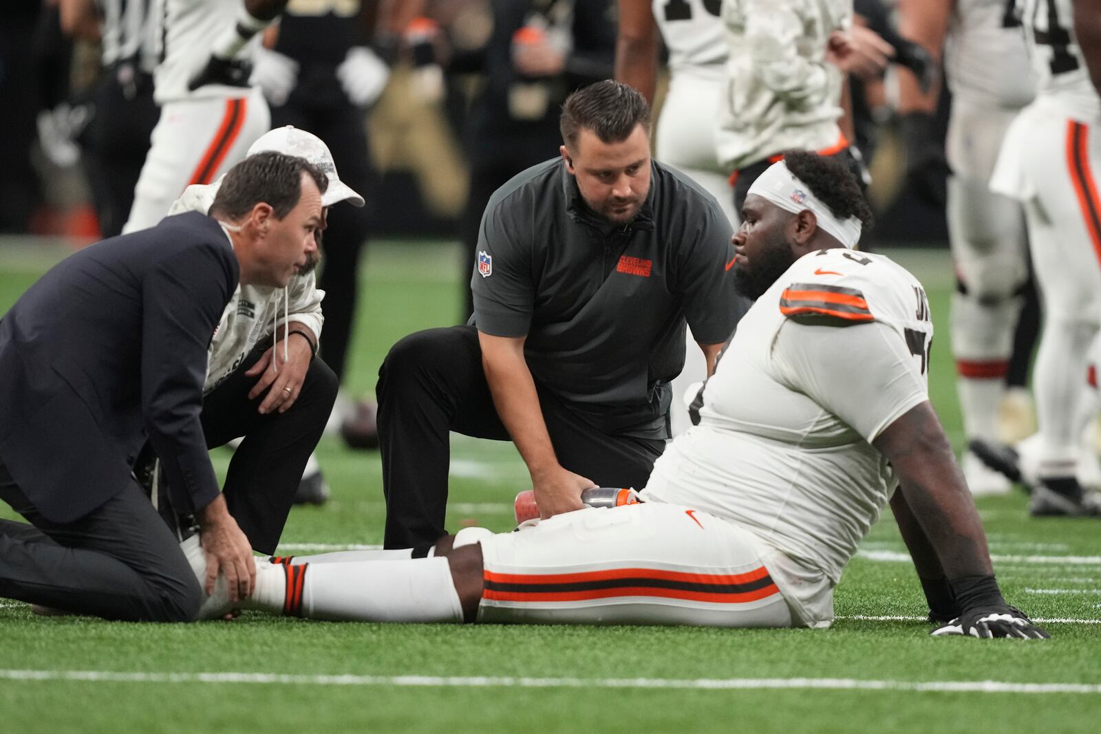 Cleveland Browns offensive tackle Dawand Jones (79) is attended to after an injury in the first half of an NFL football game against the New Orleans Saints in New Orleans, Sunday, Nov. 17, 2024. (AP Photo/Gerald Herbert)