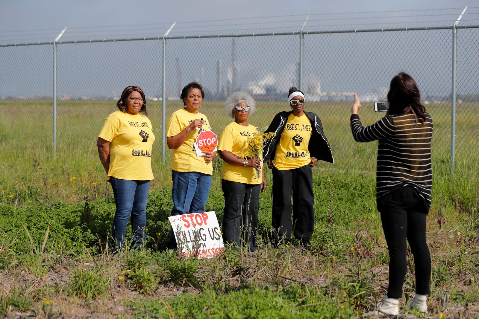 FILE - Members of RISE St. James conduct a live stream video, on property owned by Formosa, in St. James Parish, La., March 11, 2020. (AP Photo/Gerald Herbert, File)