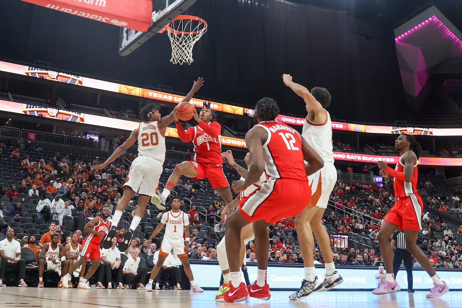 Ohio State guard Meechie Johnson Jr. (1) shoots past Texas guard Tre Johnson (20) during the first half of an NCAA basketball game Monday, Nov. 4, 2024, in Las Vegas. (AP Photo/Ian Maule)