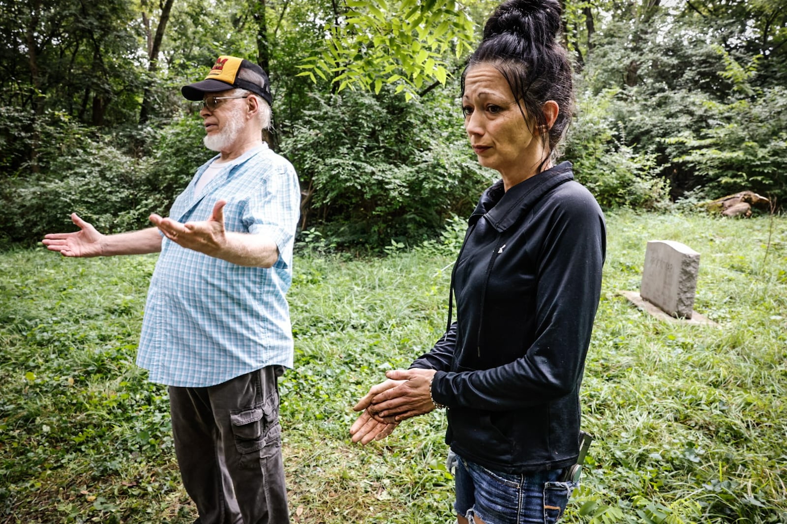 David Procuniar has a number of ancestors buried in Dille Cemetery. Jammi Colwell is a neighbor who came to help with the clean-up. JIM NOELKER/STAFF