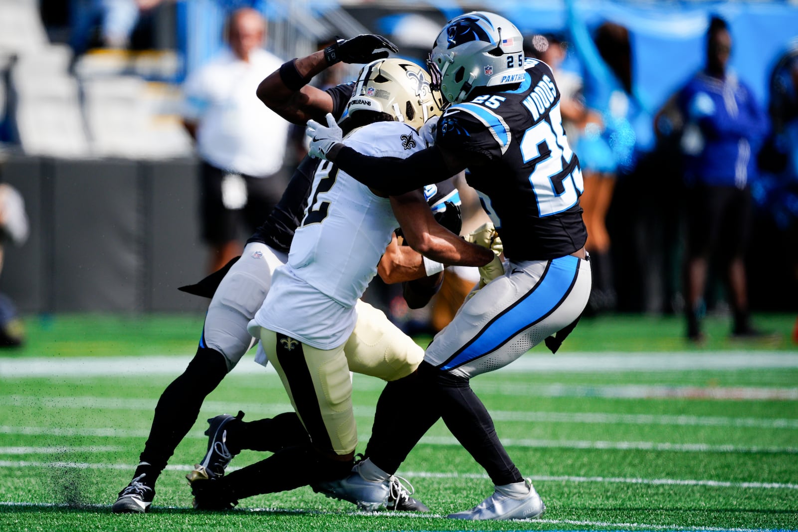 New Orleans Saints wide receiver Chris Olave gets hit by Carolina Panthers cornerback Michael Jackson and safety Xavier Woods during the first half of an NFL football game Sunday, Nov. 3, 2024, in Charlotte, N.C. Olave was taken off the field after getting hurt on the play. (AP Photo/Jacob Kupferman)