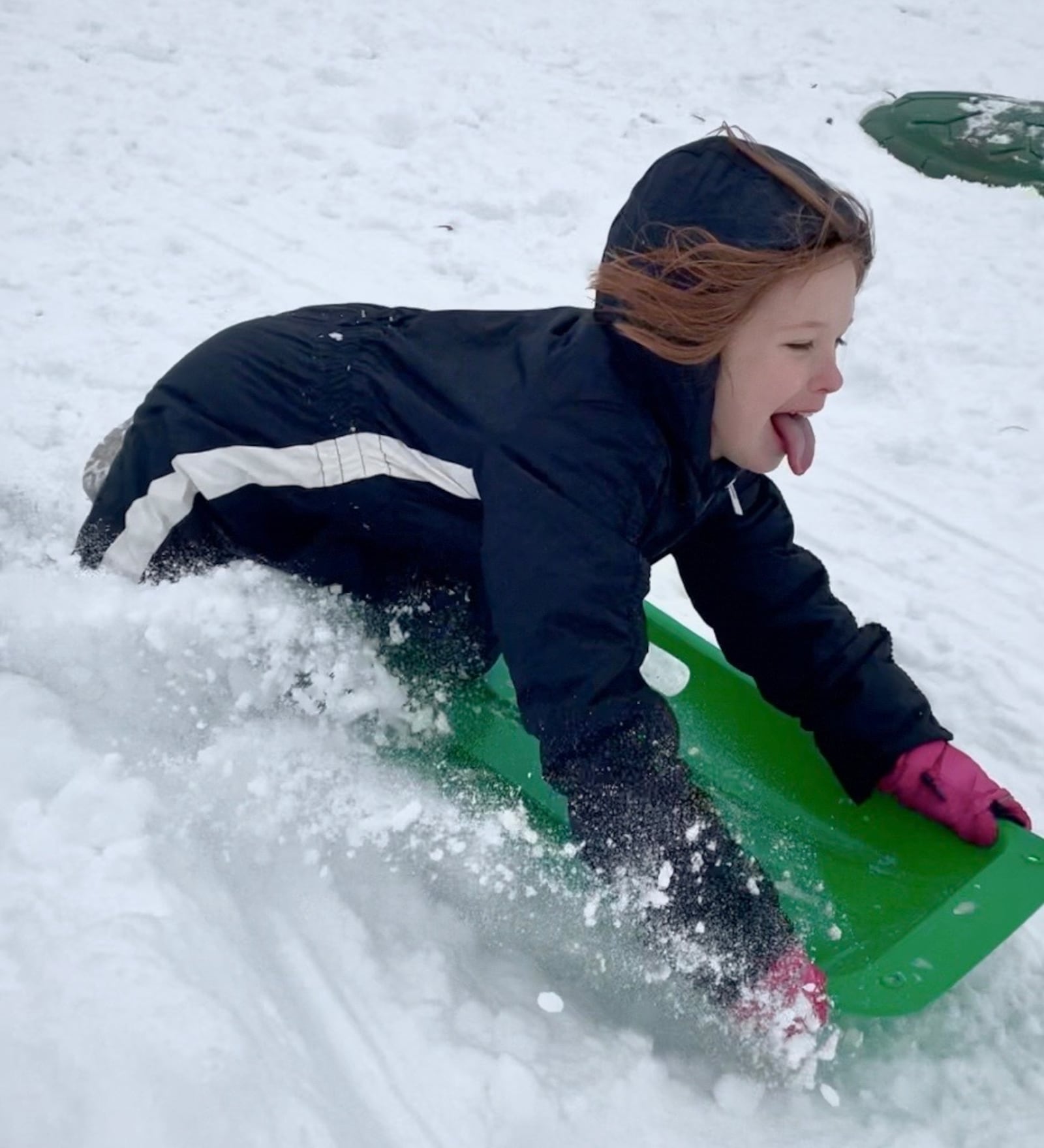 Esther Archer sleds down a hill at Bomberger Park in Dayton’s St. Anne’s Hill neighborhood on Tuesday, Jan. 7. NATALIE JONES/STAFF