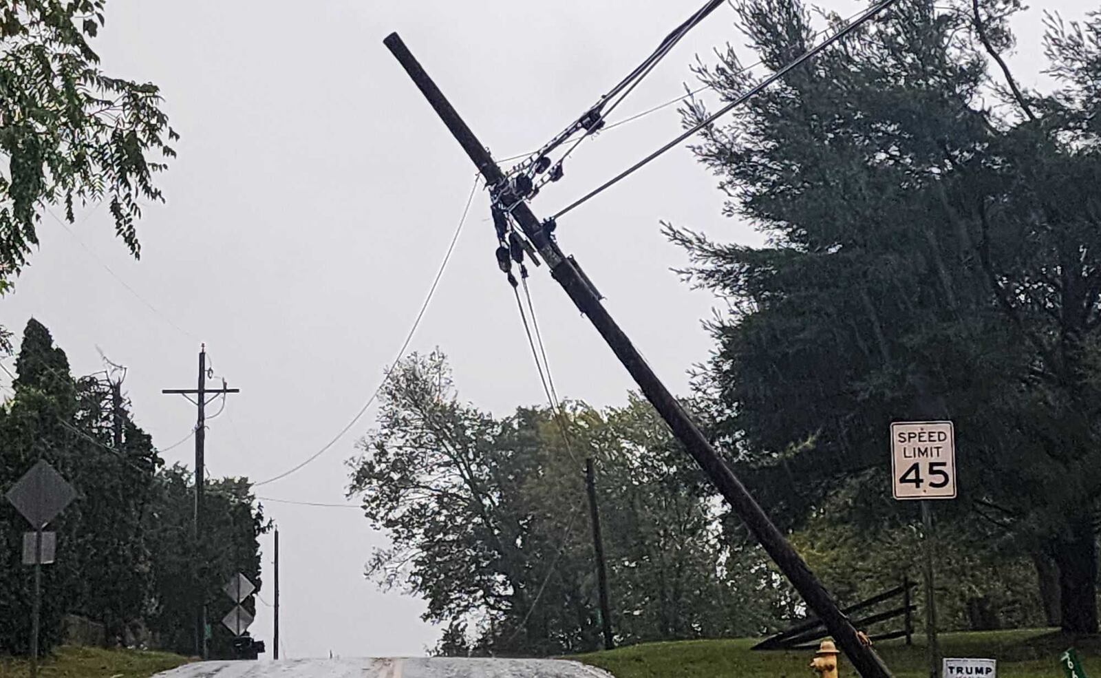 A utility pole and wires are leaning over West Alexandria Road on Friday, Sept. 27, 2024, in Madison Twp., Butler County.  NICK GRAHAM/STAFF