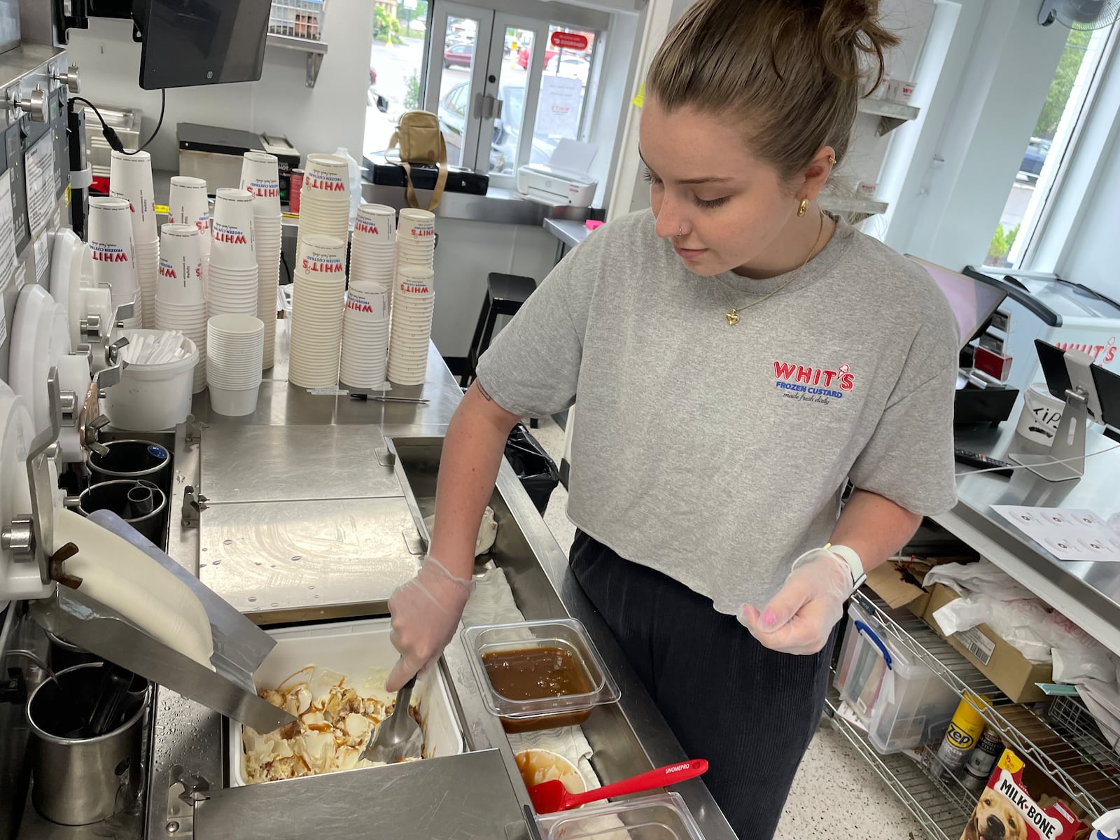 Whit’s Frozen Custard in Centerville has launched a new flavor featuring Bill’s Donut Shop’s sour cream donuts. Pictured is Emma Neace. NATALIE JONES/STAFF