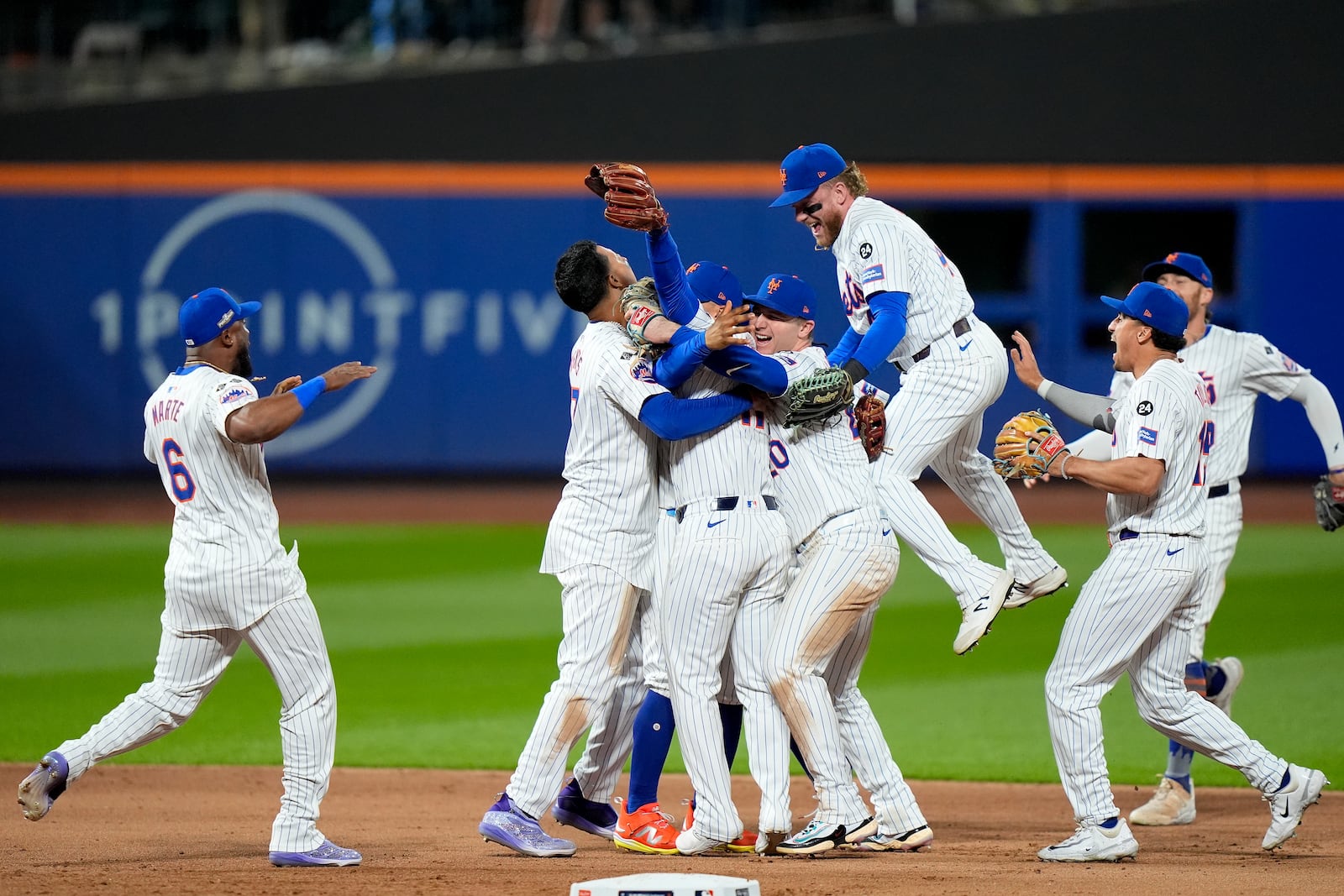 The New York Mets celebrate after defeating the Philadelphia Phillies in Game 4 of the National League baseball playoff series, Wednesday, Oct. 9, 2024, in New York. (AP Photo/Frank Franklin II)