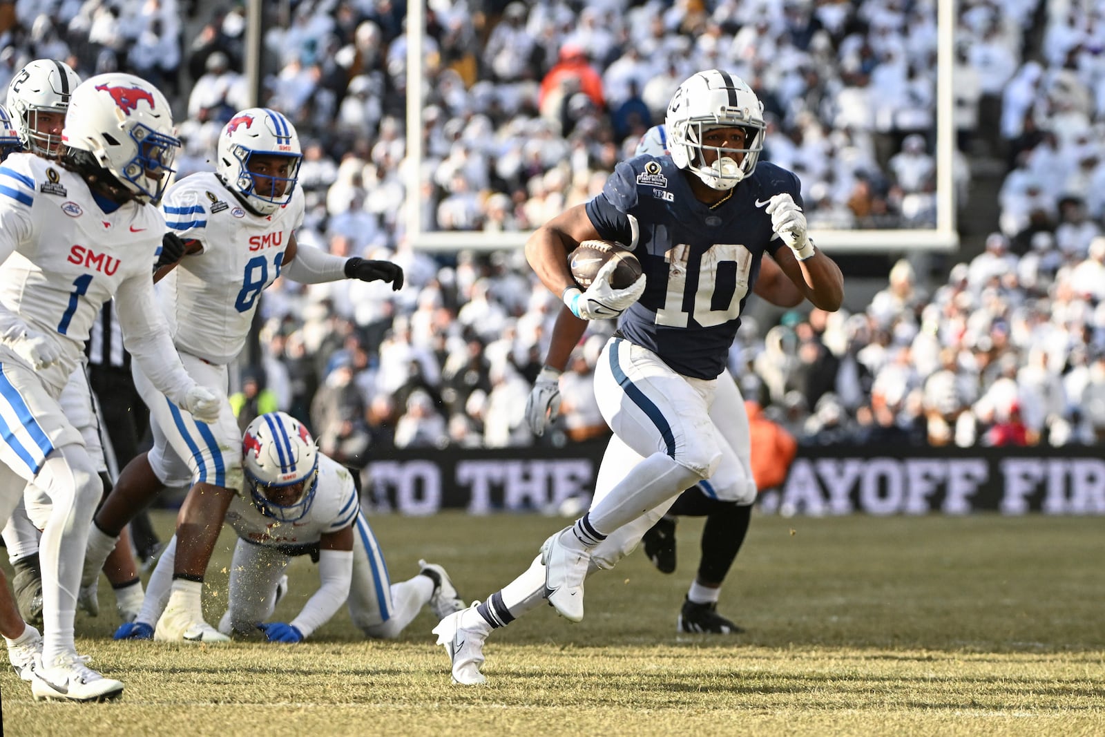 Penn State running back Nicholas Singleton (10) runs past SMU safety Brandon Crossley during the second half in the first round of the NCAA College Football Playoff, Saturday, Dec. 21, 2024, in State College, Pa. (AP Photo/Barry Reeger)