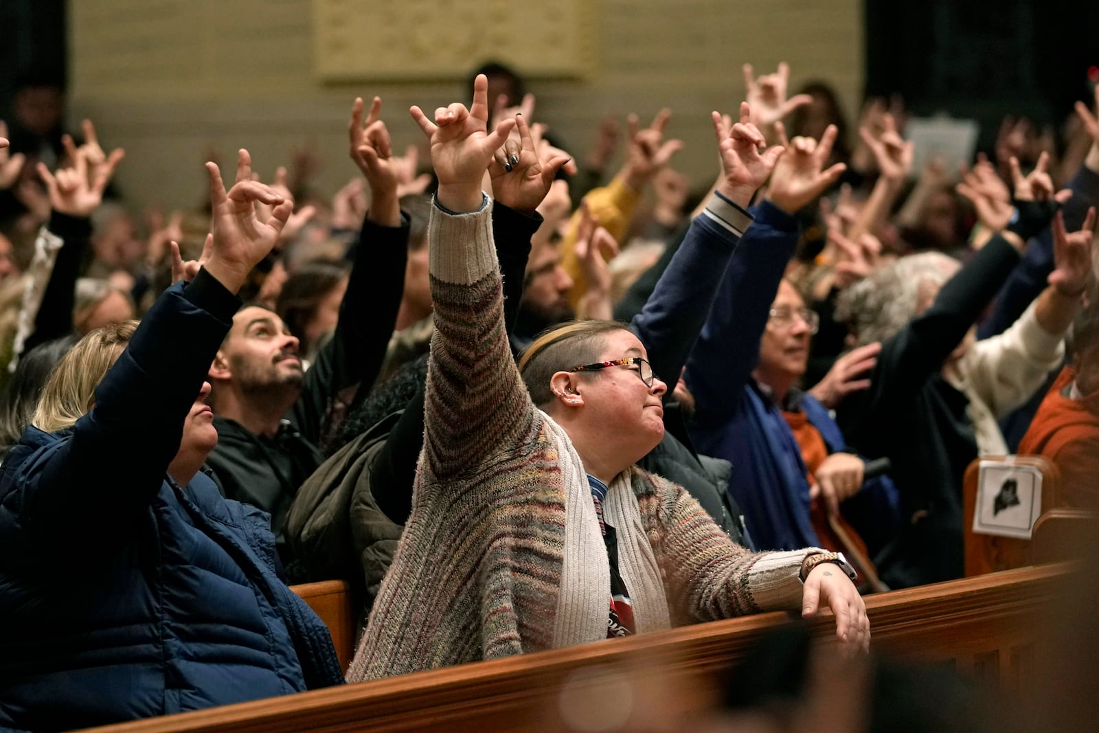 FILE - In this Sunday, Oct. 29, 2023 file photo, mourners sign "I love you" at a vigil for the victims of Wednesday's mass shootings at the Basilica of Saints Peter and Paul, in Lewiston, Maine. (AP Photo/Robert F. Bukaty, files)