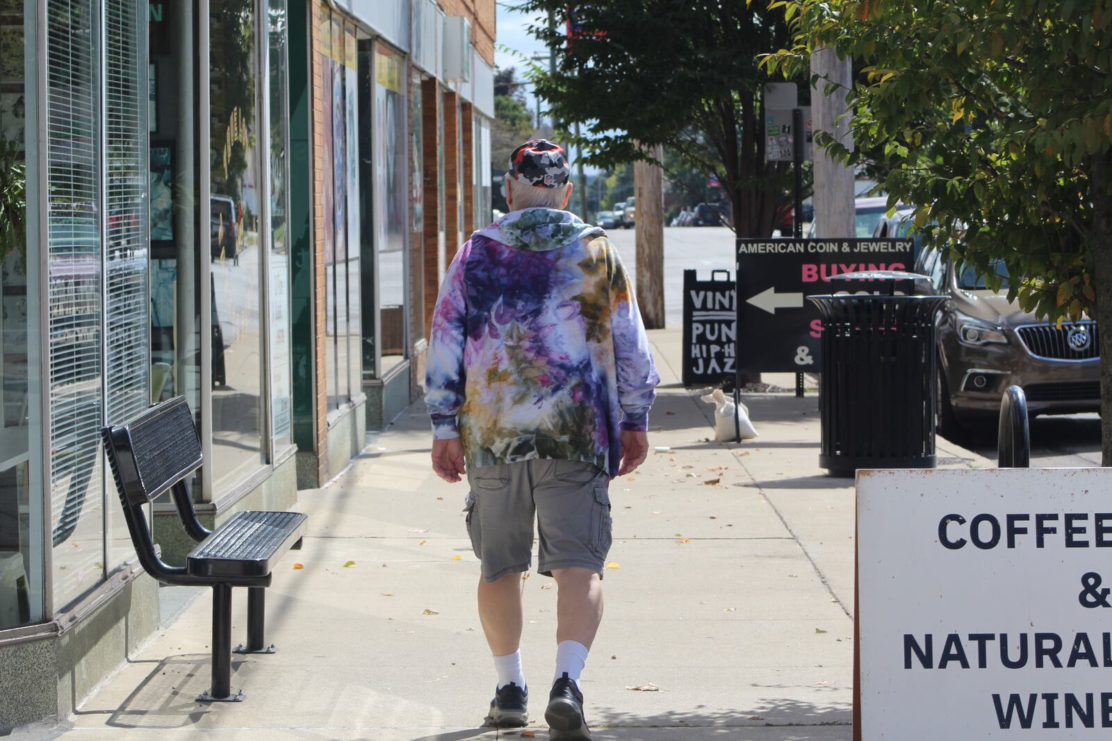 A pedestrian walks along the 700 block of Watervliet Avenue in the Belmont business district. The district has an eclectic mix of shops and restaurants. CORNELIUS FROLIK / STAFF