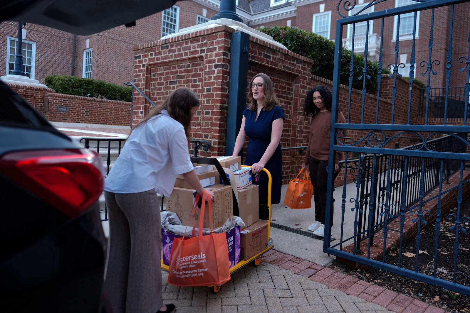 U.S.-Rep.-elect Sarah McBride, D-Del., center, incoming Deputy Chief of Staff and Communications Director, Michaela Kurinsky-Malos, left, and former field organizer for McBride's campaign, Sophie Douglas, move out of McBride's Delaware State Senate office at the Delaware Legislative Hall in Dover, Del., Tuesday, Dec. 17, 2024. (AP Photo/Carolyn Kaster)