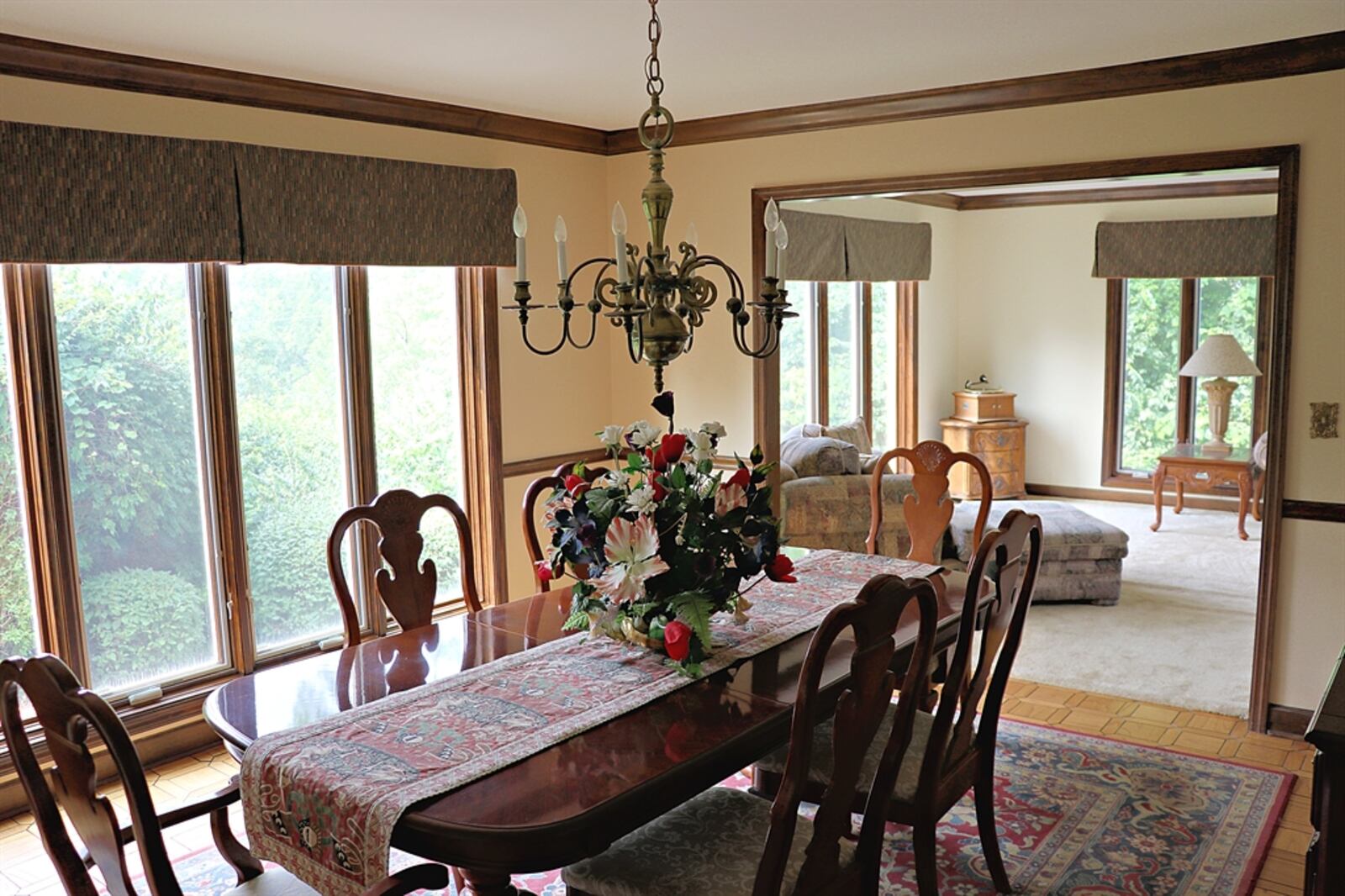 Off the living room is the formal dining room with picture window and beautiful parquet flooring,