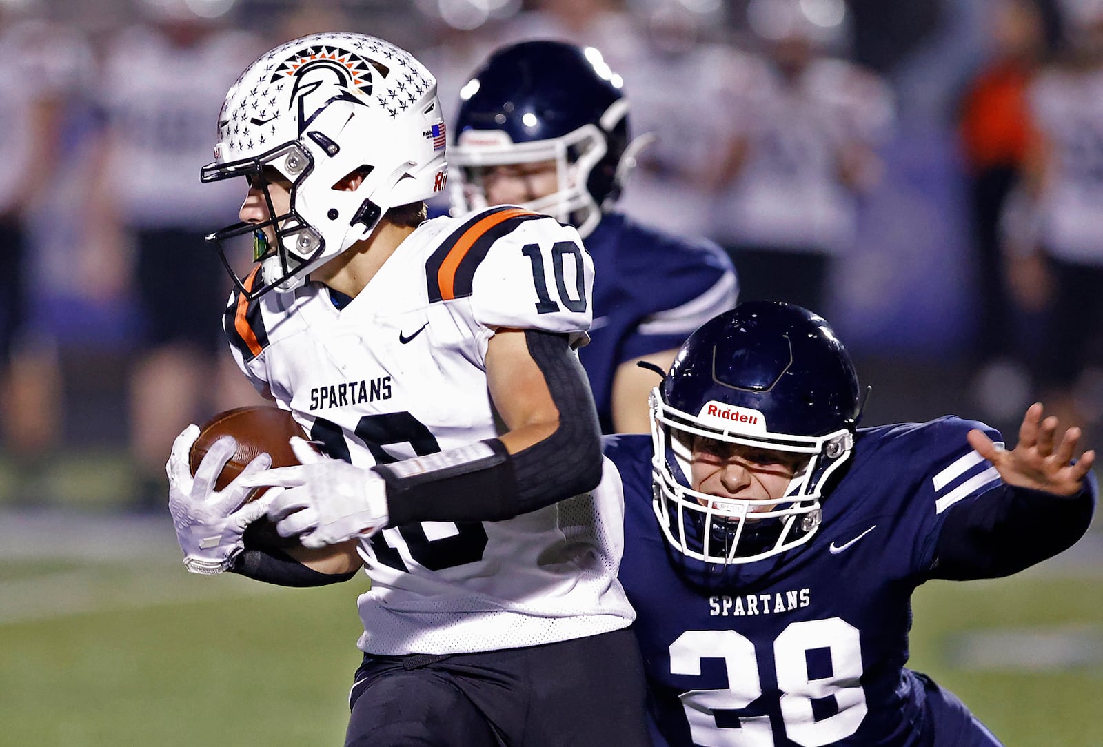 Waynesville's Garrett Lundy avoids a tackle by Valley View's Brodie Hopkins as he carries the ball for a touchdown during Friday's playoff game. BILL LACKEY/STAFF