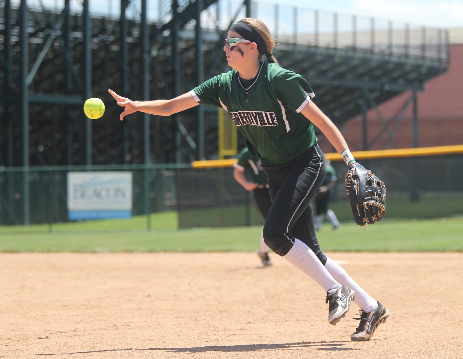 Greenville second baseman Haleigh Mayo flips the ball to first base for an out against Clinton-Massie in a Division II regional semifinal on Wednesday, May 23, 2018, at Mason High School. David Jablonski/Staff