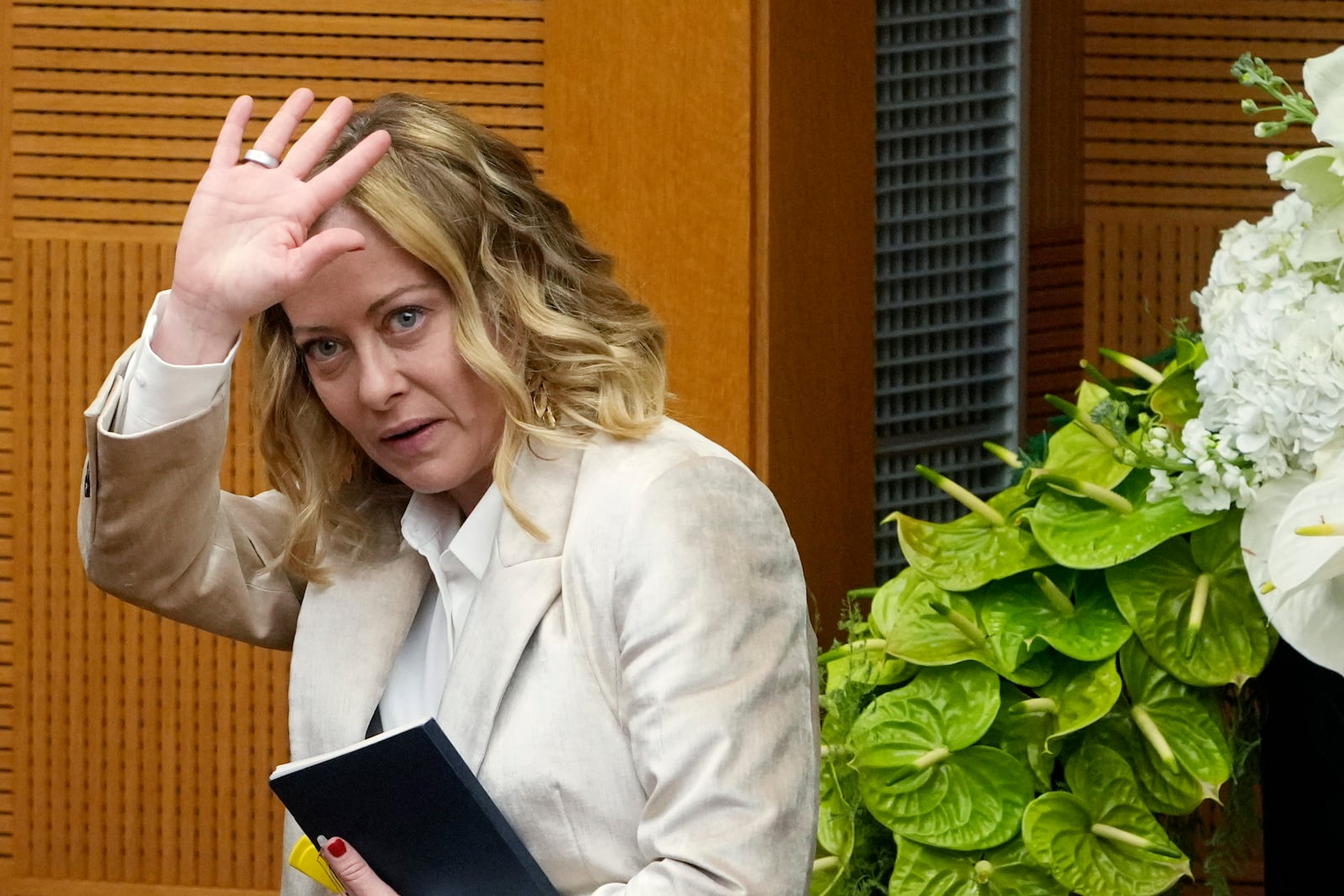 Italian Premier Giorgia Meloni waves at the end of the 2024 year-end press conference, in Rome, Thursday, Jan. 9, 2025. (AP Photo/Alessandra Tarantino)