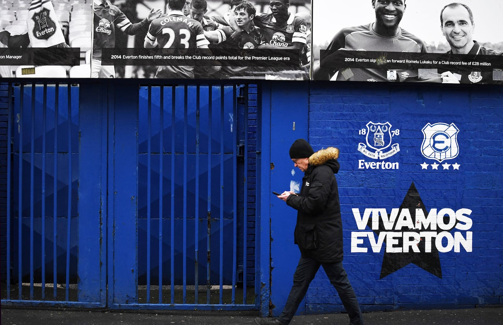 A man walks outside Goodison Park as the Premier League soccer match between Everton and Liverpool is called off due to storm Darragh at Goodison Park, in Liverpool, England, Saturday Dec 7, 2024. (AP Photo/Rui Vieira)