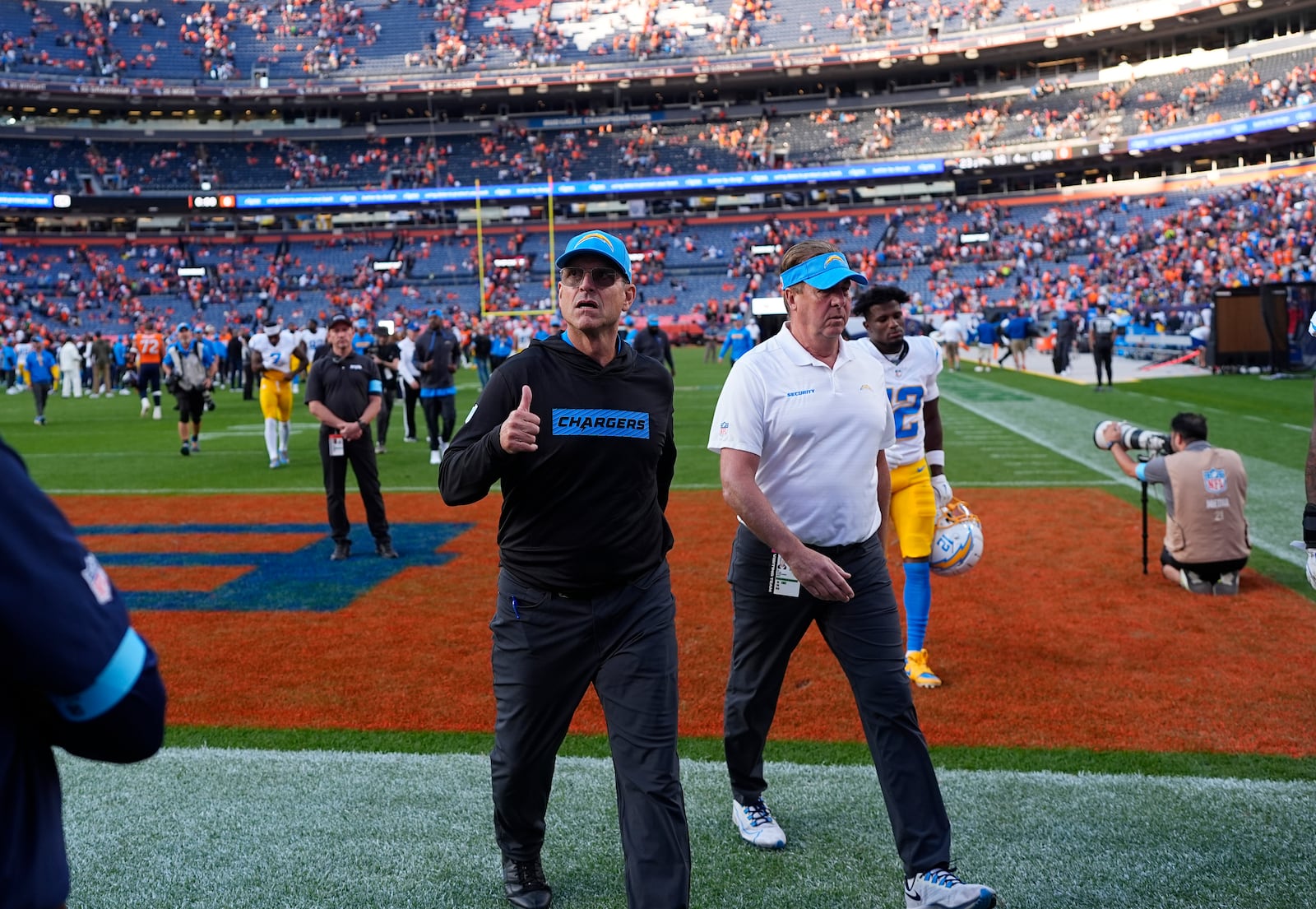 Los Angeles Chargers head coach Jim Harbaugh gestures to the crowd as he leaves the field after an NFL football game against the Denver Broncos, Sunday, Oct. 13, 2024, in Denver. (AP Photo/David Zalubowski)