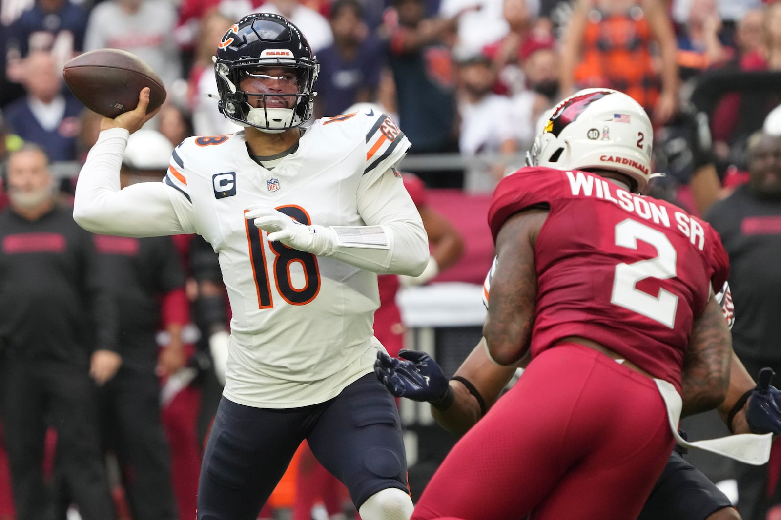 Chicago Bears quarterback Caleb Williams (18) throws under pressure from Arizona Cardinals linebacker Mack Wilson Sr. (2) during the first half of an NFL football game, Sunday, Nov. 3, 2024, in Glendale, Ariz. (AP Photo/Rick Scuteri)