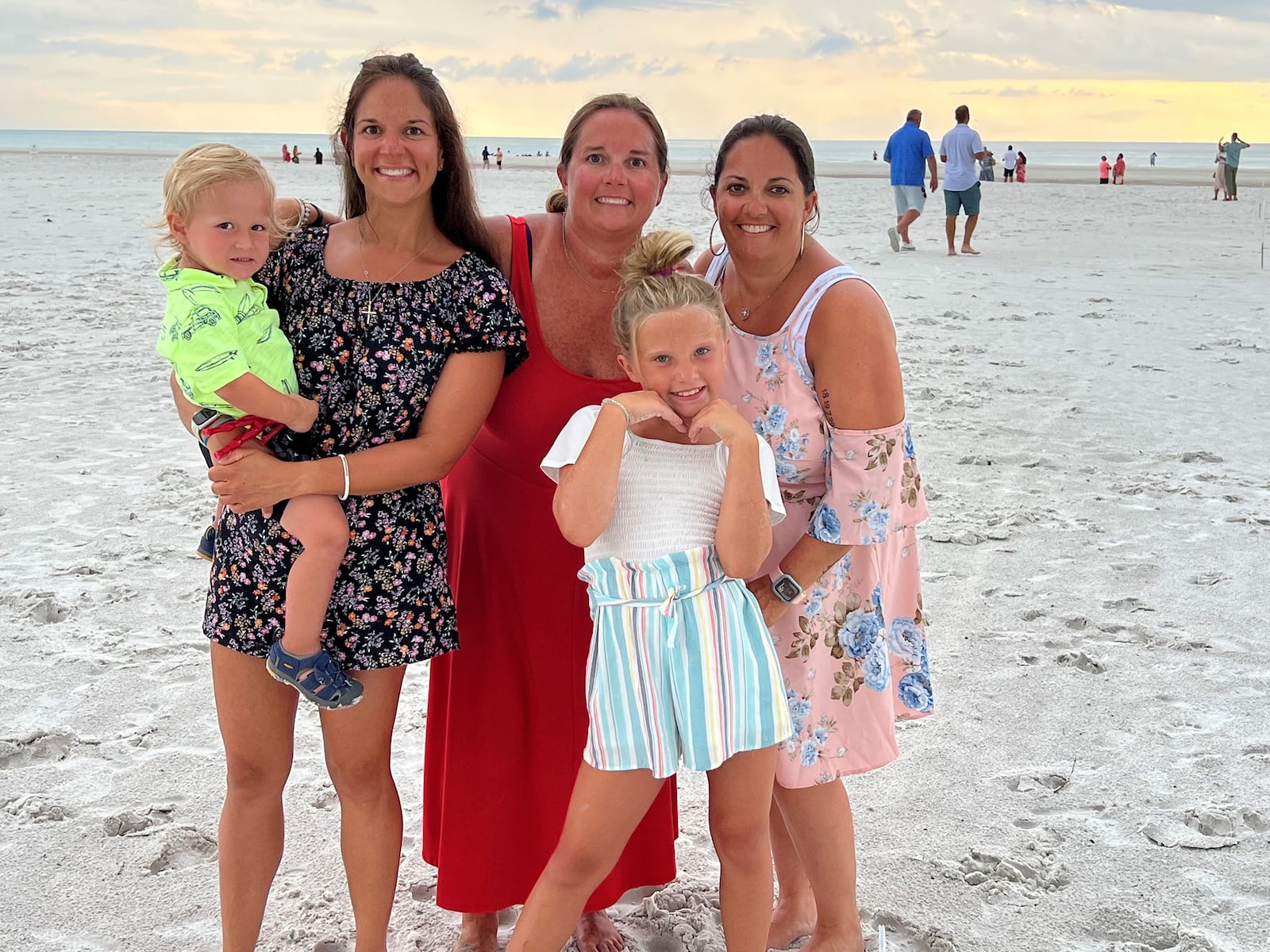 Becky Edgren's daughters and two of their children enjoying Siesta Key Beach on a family vacation. This vacation was only the third time the entire family was able to get away since all three girls, from left Britni Hurst (holding son Vance Hurst) Megann Eversole and Lara Harshbarger, (Megann's daughter Gracie in front) joined their mother's company.  CONTRIBUTED