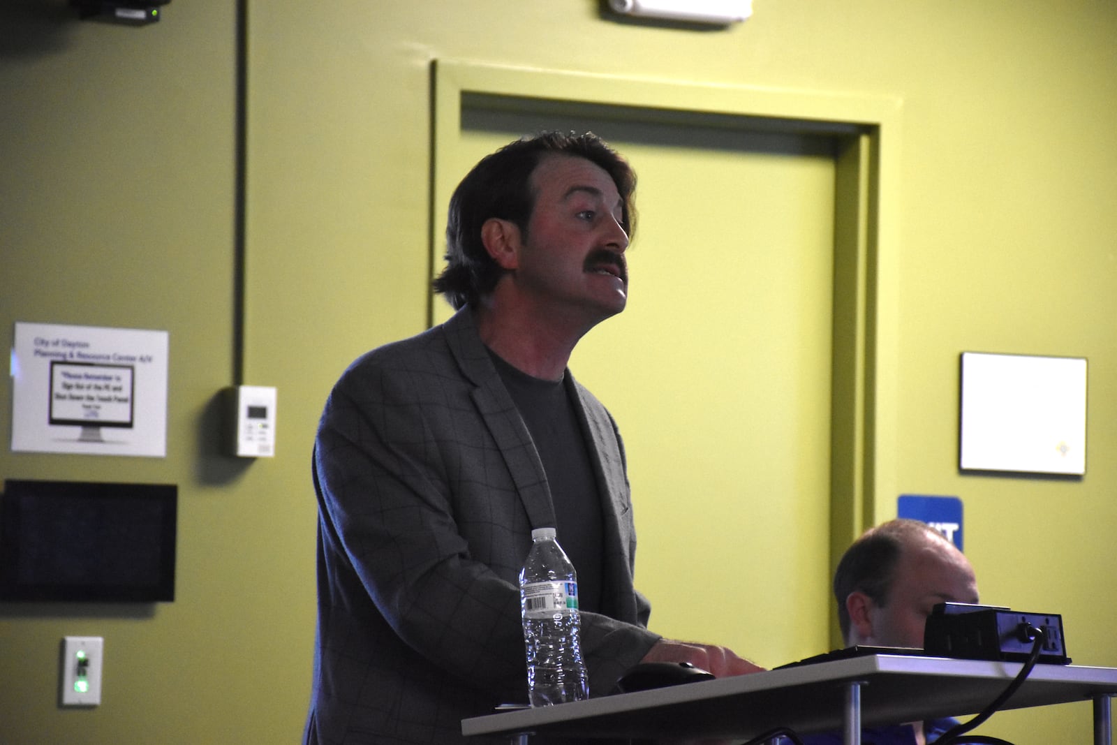 Mike Schommer, president of the Walnut Hills Neighborhood Association, speaks at a Dayton Board of Zoning Appeals meeting about Liberty High School. CORNELIUS FROLIK / STAFF