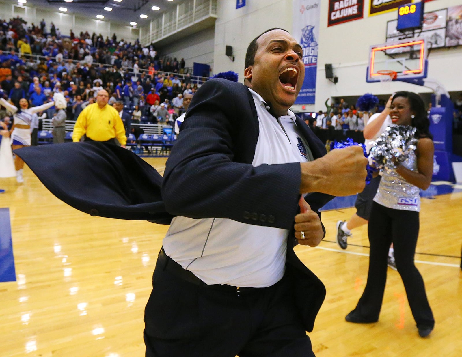 Georgia State head coach Ron Hunter reacts to winning the Sunbelt Men’s Basketball Regular Season Championship charging the fans after beating Georgia Southern 72-55 in a basketball game on Saturday, March 7, 2015, in Atlanta. Made with a Canon EOS-1DX camera, 16-35MM lens at focal length 16MM, 1/1000 second, F 4, and an ISO of 6400. Curtis Compton / ccompton@ajc.com