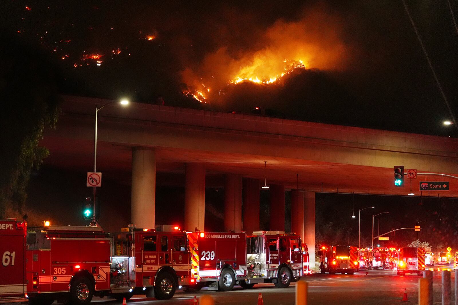 Apparatus sits on Sepulveda Blvd. as fire burns along Interstate 405, Thursday, Jan. 23, 2025, in Los Angeles. (AP Photo/Mark J. Terrill)