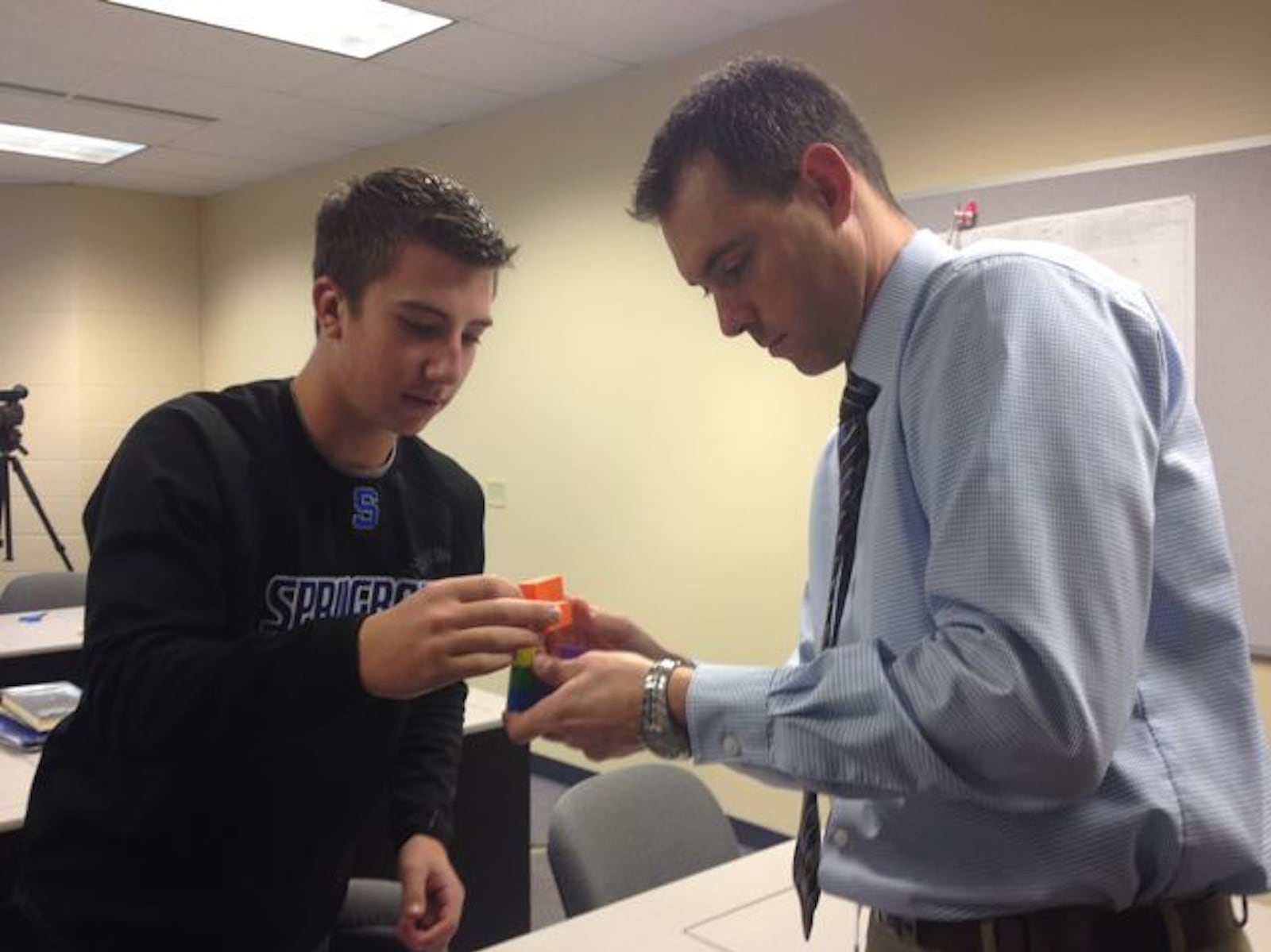 Springboro High School Principal Kyle Martin, right, is part of a community group of local leaders looking for ways to identify inclusion and diversity and work with students and staff, including two who have created a presentation, on these issues.
Here he is pictured trying out 3D puzzles designed and manufactured by students in 2015.
CONTRIBUTED