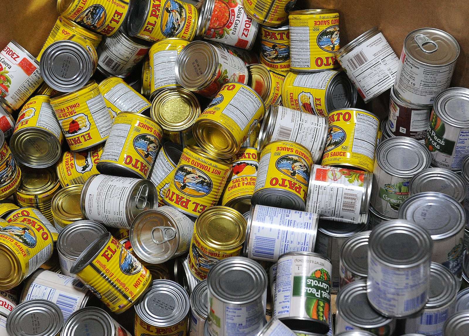 Large bins of canned goods, like peas and tomatoes, take up space in the  Foodbank Inc. warehouse. MARSHALL GORBY\STAFF