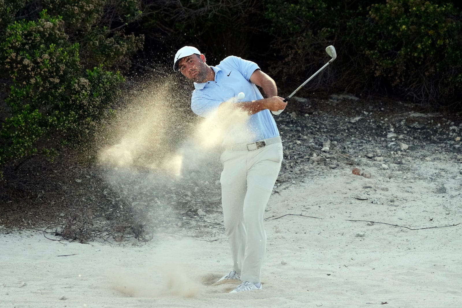 Scottie Scheffler, of the United States, hits out of the sand on the 16th hole during the third round of the Hero World Challenge PGA Tour at the Albany Golf Club in New Providence, Bahamas, Saturday, Dec. 7, 2024. (AP Photo/Fernando Llano)