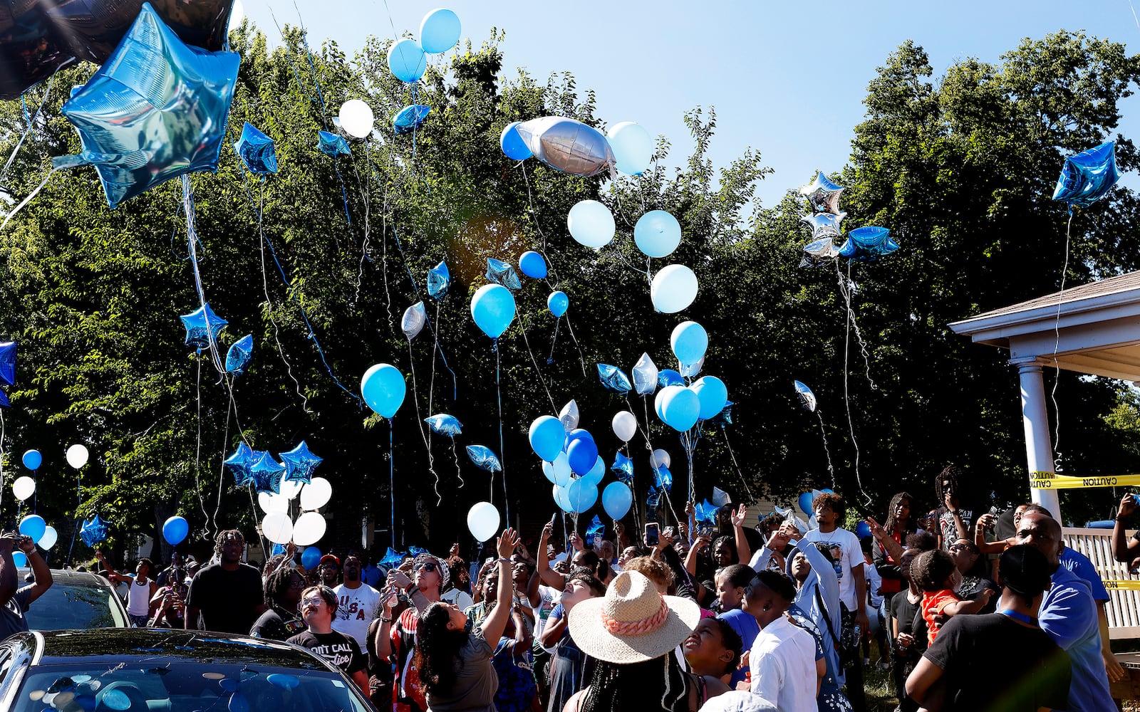 A balloon release was held Sunday, June 30, 2024 near the corner of Williams St. and Negley Pl. for a young man shot and killed my Dayton Police. MARSHALL GORBY\STAFF