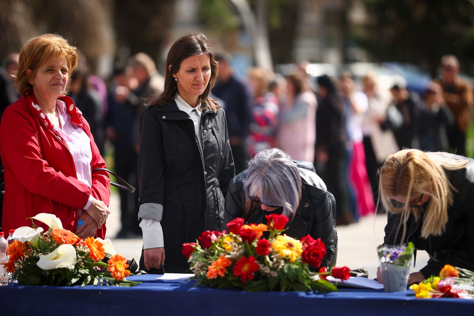 People wait to write condolence messages for the victims of a massive nightclub fire in the town of Kocani, North Macedonia, Monday, March 17, 2025, (AP Photo/Armin Durgut)