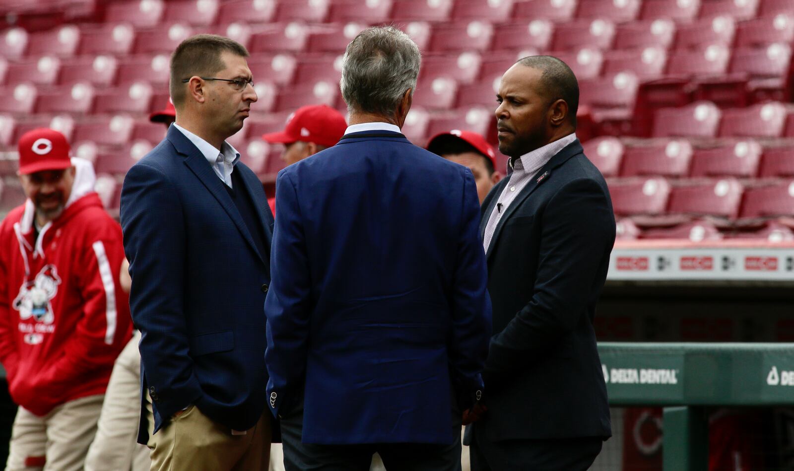 Nick Krall, left, of the Reds talks to Chris Welsh and Barry Larkin Opening Day on April 12, 2022, at Great American Ball Park in Cincinnati. David Jablonski/Staff