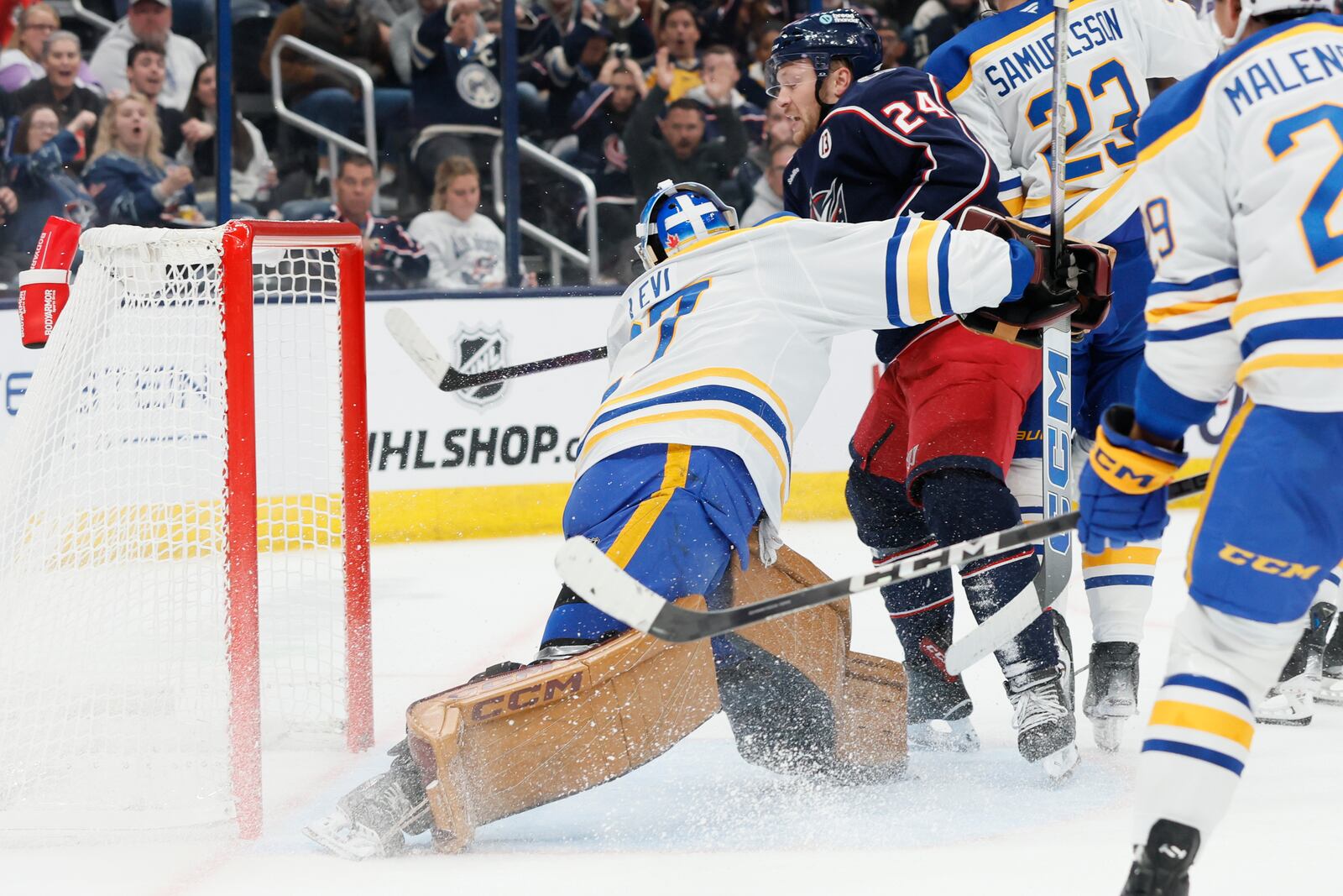 Columbus Blue Jackets' Mathieu Olivier, right, scores a goal against Buffalo Sabres' Devon Levi during the second period of an NHL hockey game Thursday, Oct. 17, 2024, in Columbus, Ohio. (AP Photo/Jay LaPrete)