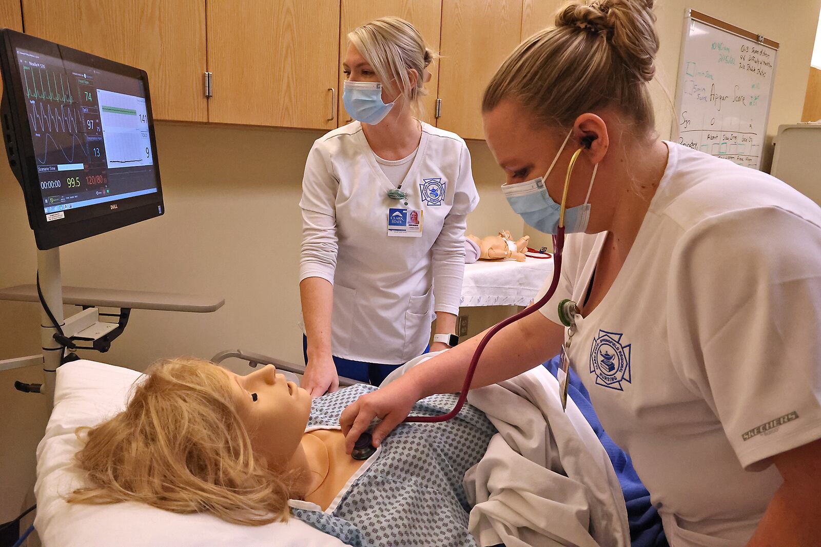 Kristin Cosby, left, and Kristin Sebastian, nursing students at Clark State, in one of the school's nursing labs. BILL LACKEY/STAFF