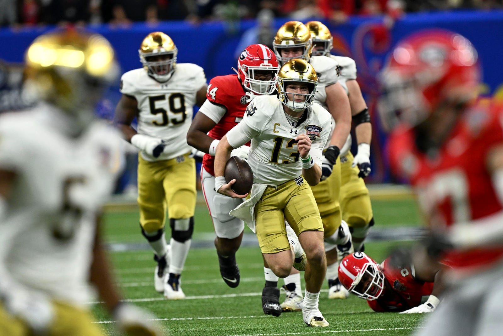 FILE - Notre Dame quarterback Riley Leonard (13) scrambles up field during the first half against Georgia in the quarterfinals of a College Football Playoff, Thursday, Jan. 2, 2025, in New Orleans. (AP Photo/Matthew Hinton, File)