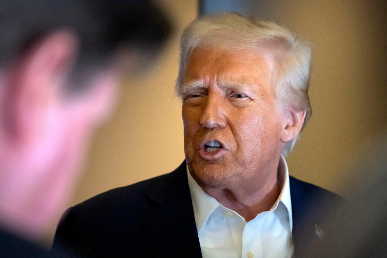 President Donald Trump speaks to reporters aboard Air Force One as he travels from Las Vegas to Miami on Saturday, Jan. 25, 2025. (AP Photo/Mark Schiefelbein)