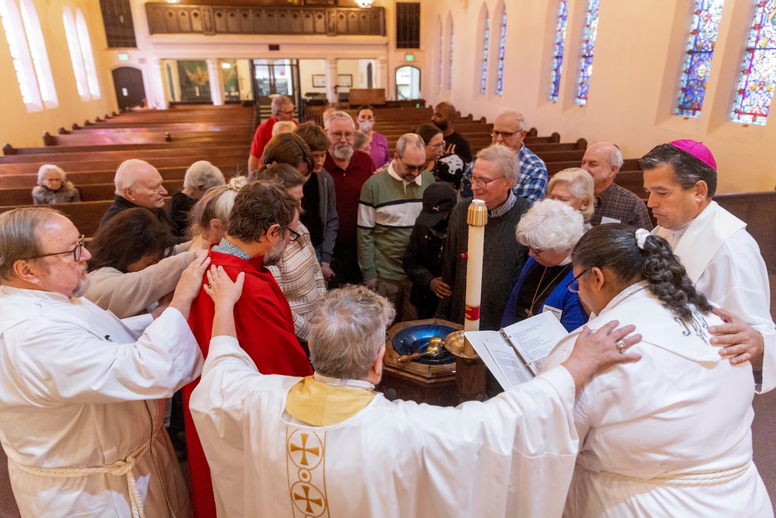 Faithful pray at a religious service in the aftermath of the Eaton Fire at Trinity Lutheran Church Sunday, Jan. 12, 2025 in Pasadena, Calif. (AP Photo/Ethan Swope)