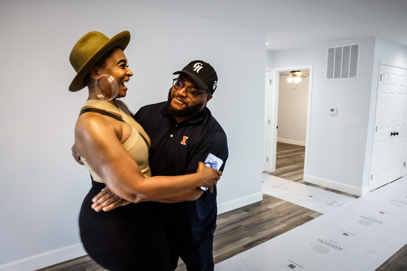 Bradley Kuydendall celebrates with his realtor Toya Webb the acquisition of his new home on Auburn Ave. in Dayton Friday May 17, 2024. Kuykendall was able to purchase the home thru Pathway to Homeownership program which helps people with low to moderate income, first-time homebuyers. JIM NOELKER/STAFF