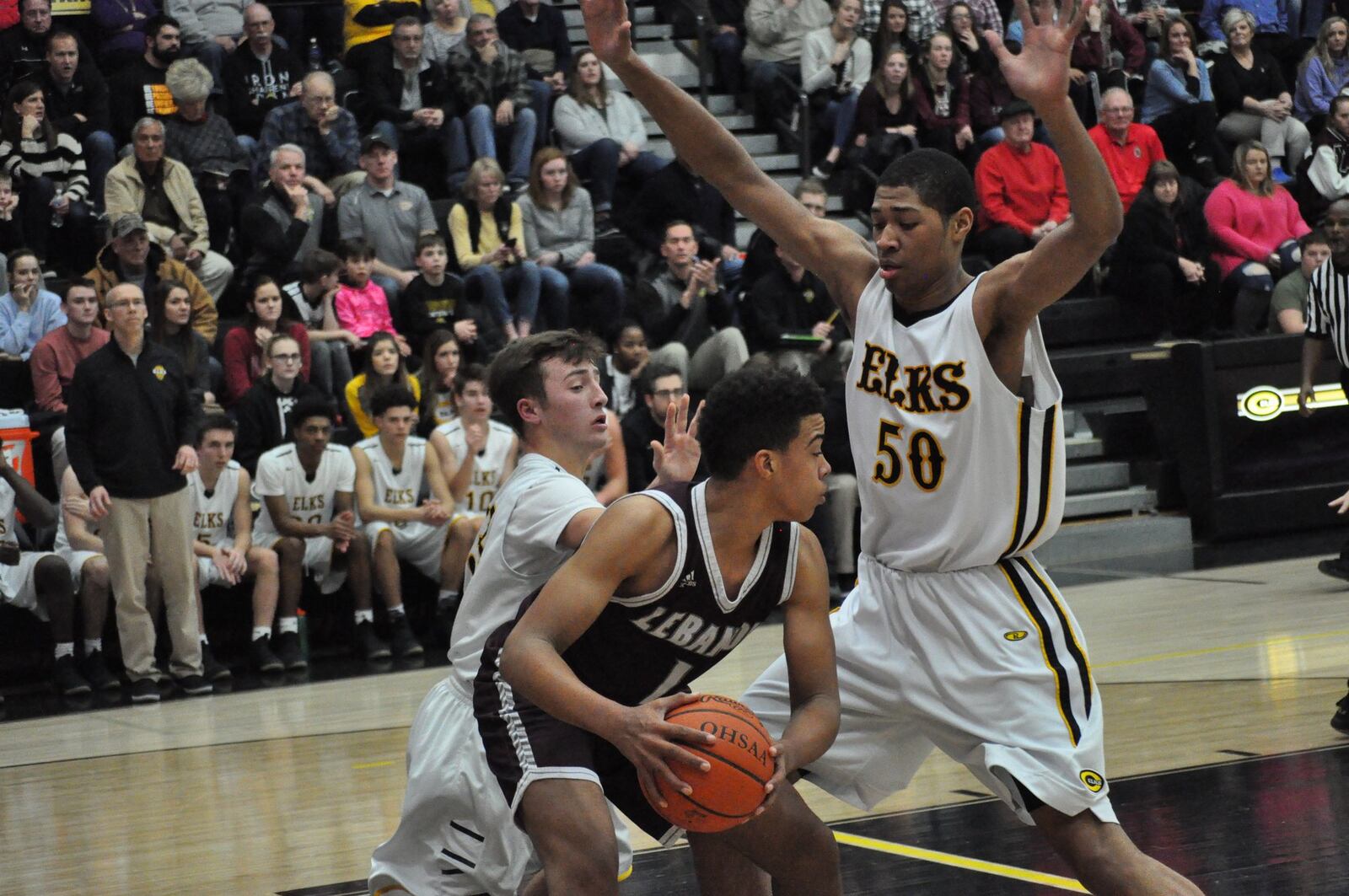 Lebanon’s Harrison Hoofkin tries to get something going offensively as Centerville sophomore Mo Njie (right) applies the pressure during Centerville’s 51-29 win at home Friday night. NICK DUDUKOVICH / CONTRIBUTED