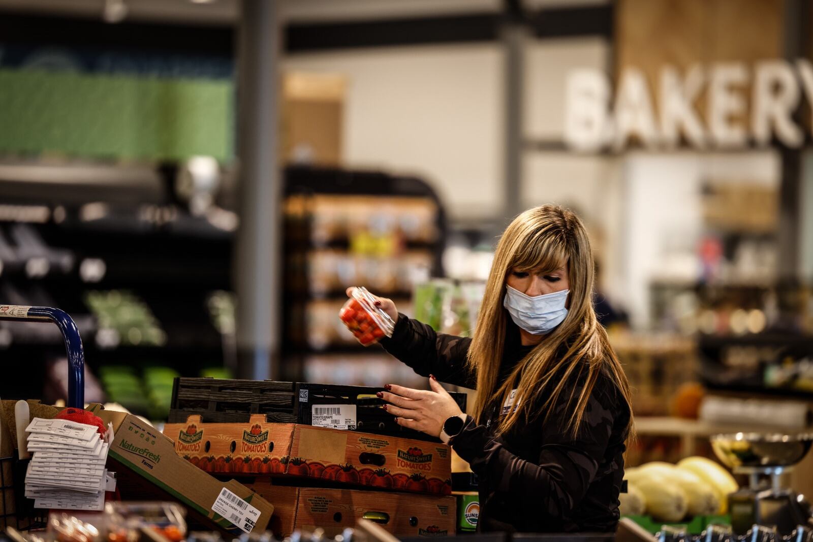 Kroger employee Ciara Baker stacks produce at the new Springboro Kroger on West Central Avenue on Wednesday, Oct. 20, 2021. JIM NOELKER/STAFF