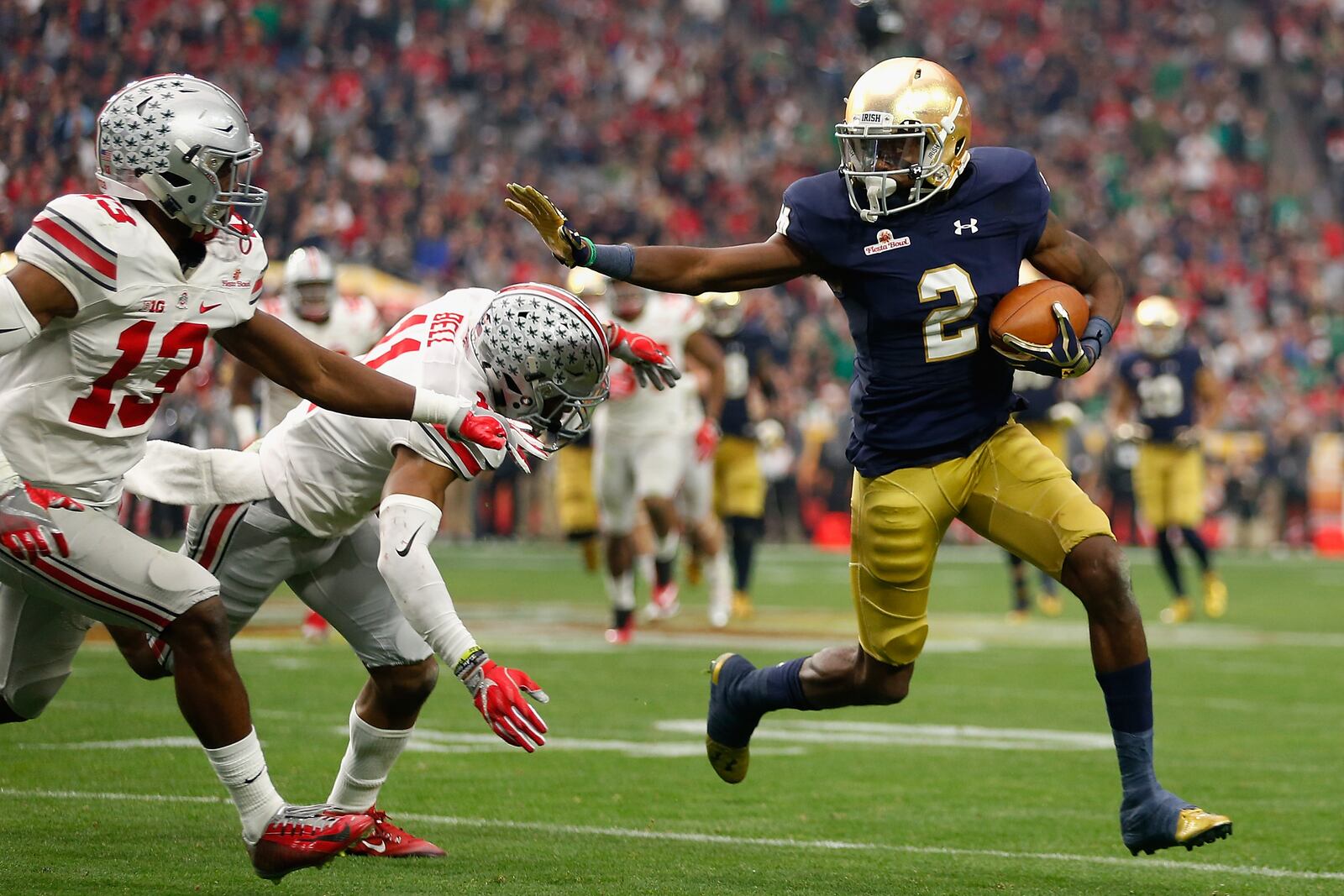 GLENDALE, AZ - JANUARY 01: Wide receiver Chris Brown #2 of the Notre Dame Fighting Irish runs with the football against safety Vonn Bell #11 of the Ohio State Buckeyes (back) and cornerback Eli Apple #13 (front) during the third quarter of the BattleFrog Fiesta Bowl at University of Phoenix Stadium on January 1, 2016 in Glendale, Arizona. The Buckeyes defeated the Fighting Irish 44-28. (Photo by Christian Petersen/Getty Images)