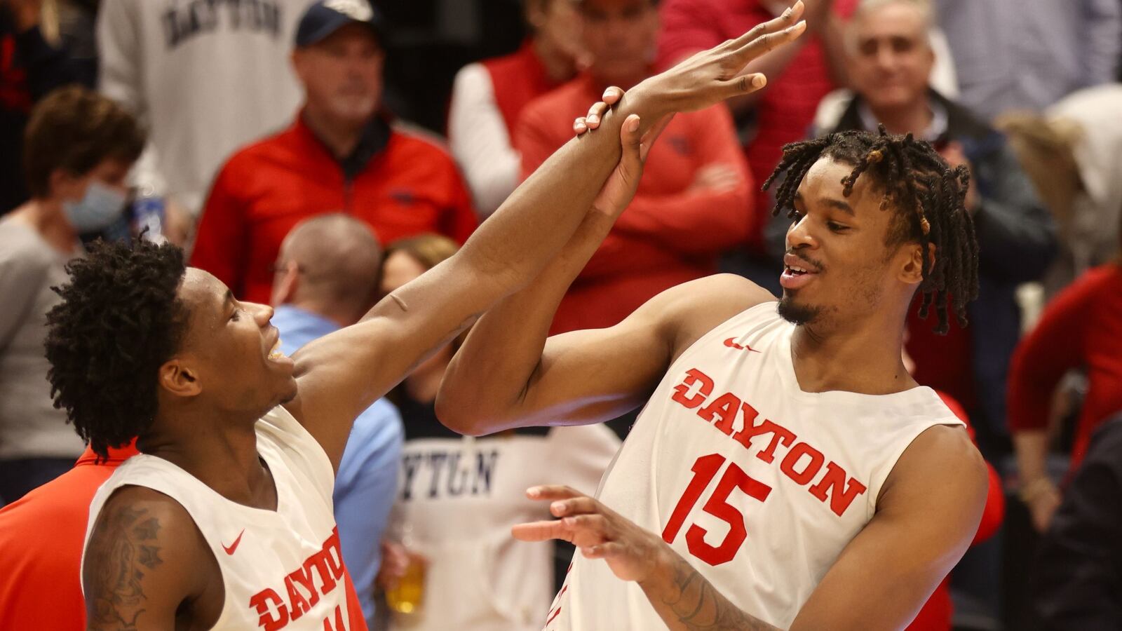 Dayton's Malachi Smith and DaRon Holmes laugh in the handshake line after a victory against La Salle on Tuesday, Feb. 28, 2023, at UD Arena. David Jablonski/Staff