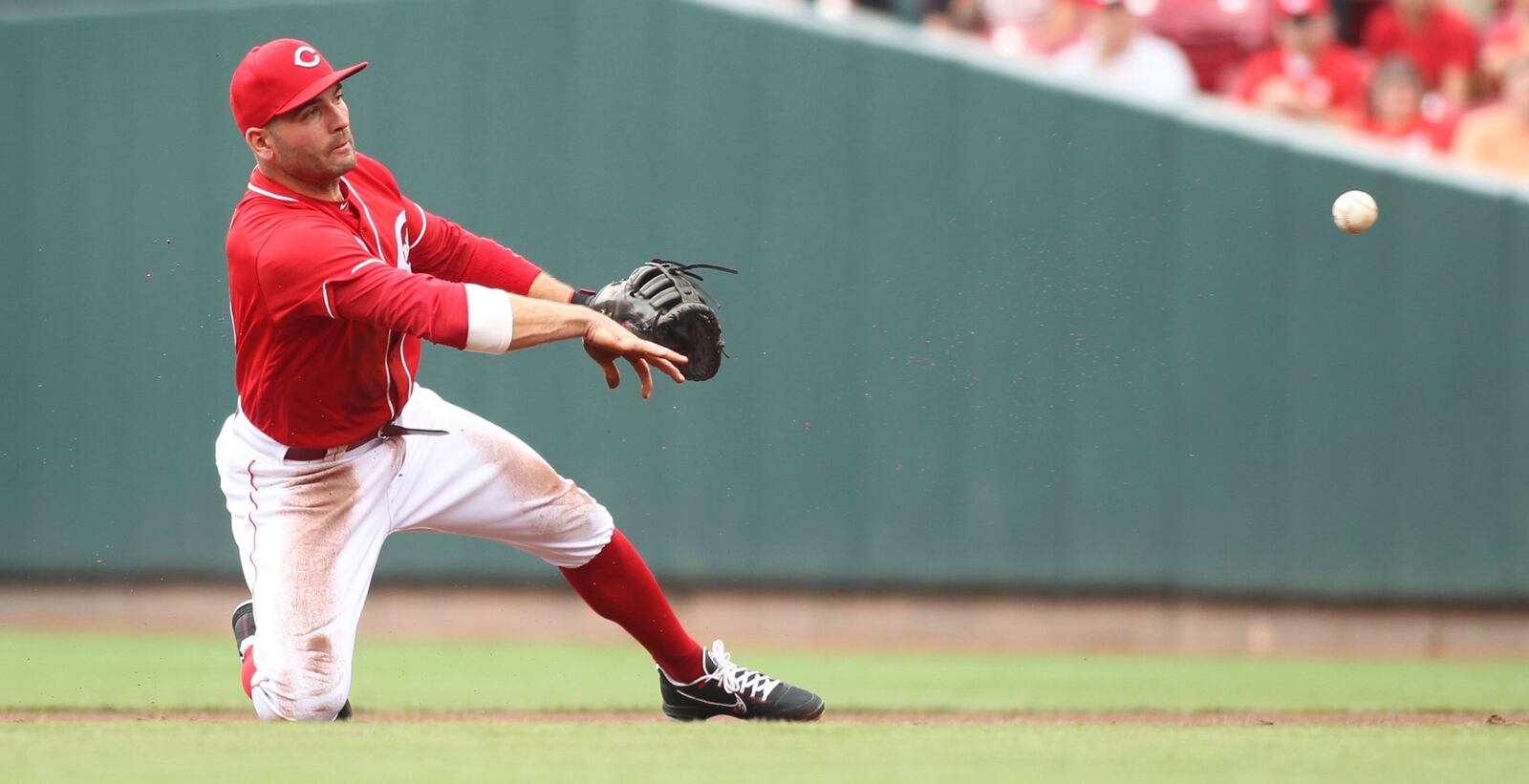 Reds first baseman Joey Votto throws to first for an out against the Pirates on Sunday, July 22, 2018, at Great American Ball Park in Cincinnati. David Jablonski/Staff