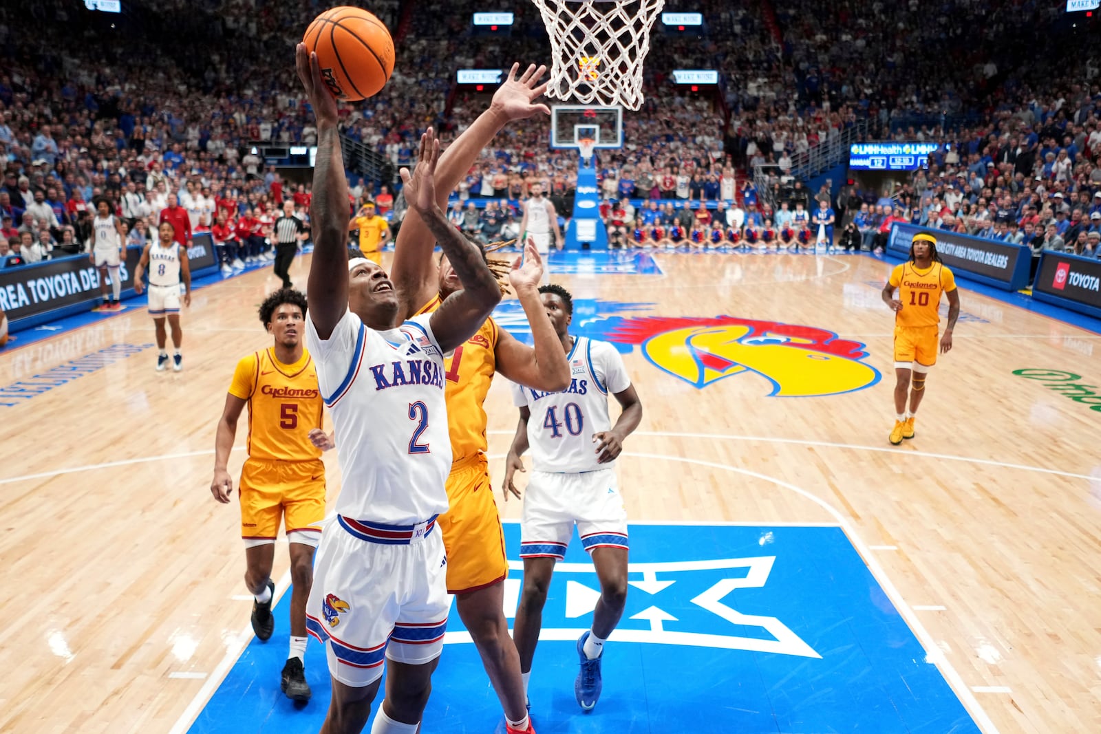 Kansas guard AJ Storr (2) puts up a shot during the first half of an NCAA college basketball game against Iowa State, Monday, Feb. 3, 2025, in Lawrence, Kan. (AP Photo/Charlie Riedel)