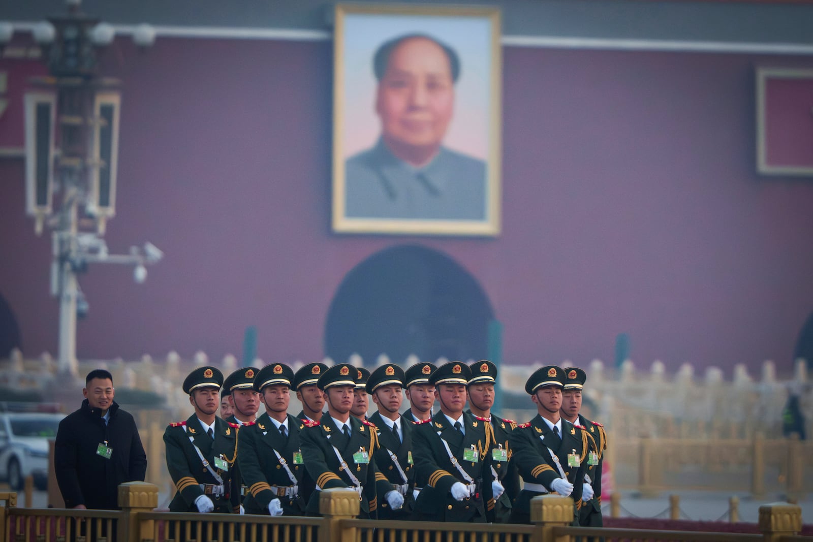 Chinese paramilitary personnel march past a portrait of former Chinese leader Mao Zedong at Tiananmen Square before the opening session of the National People's Congress (NPC) at the Great Hall of the People in Beijing, China, Wednesday, March 5, 2025. (AP Photo/Vincent Thian)