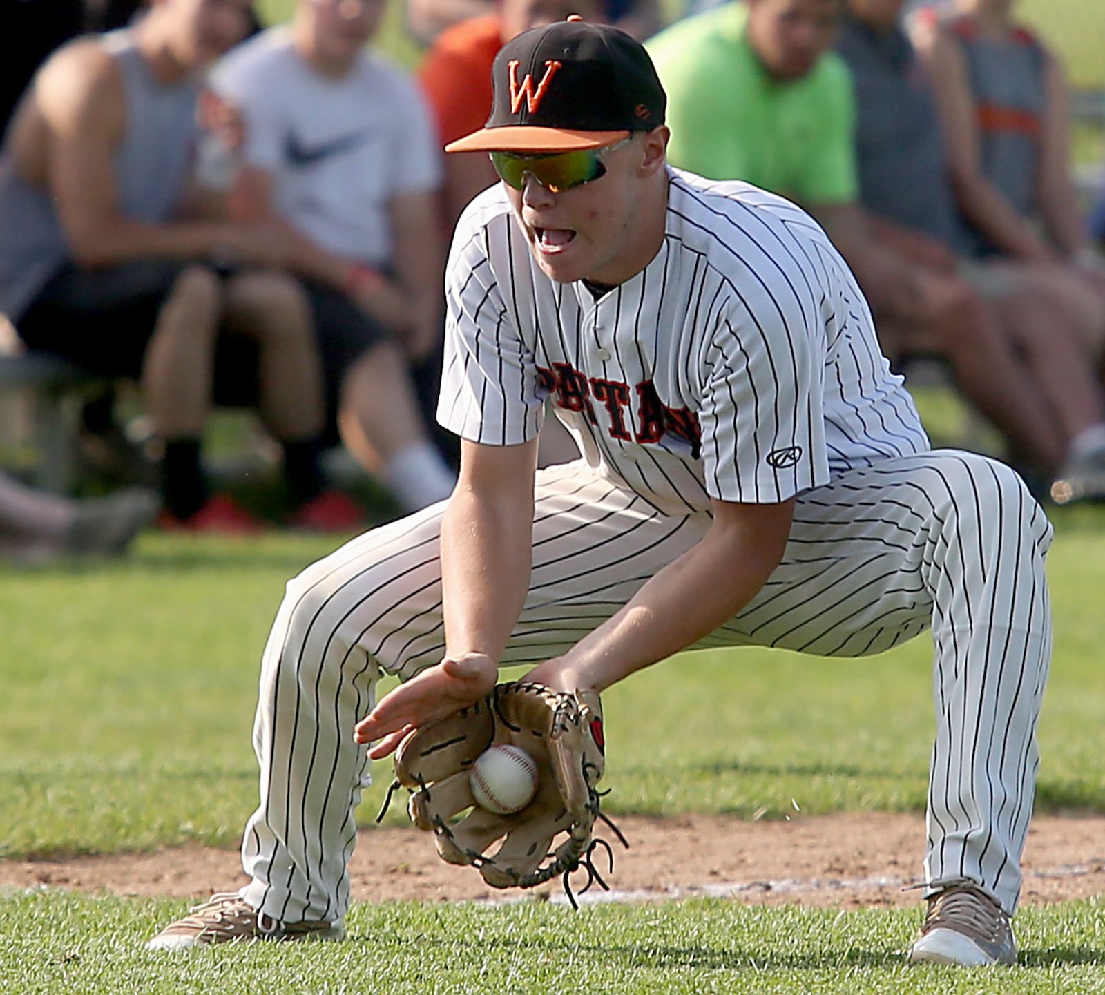 Waynesville third baseman Drake Stiles fields a Chaminade Julienne ground ball Friday during their Division II regional semifinal at Mason. CONTRIBUTED PHOTO BY E.L. HUBBARD