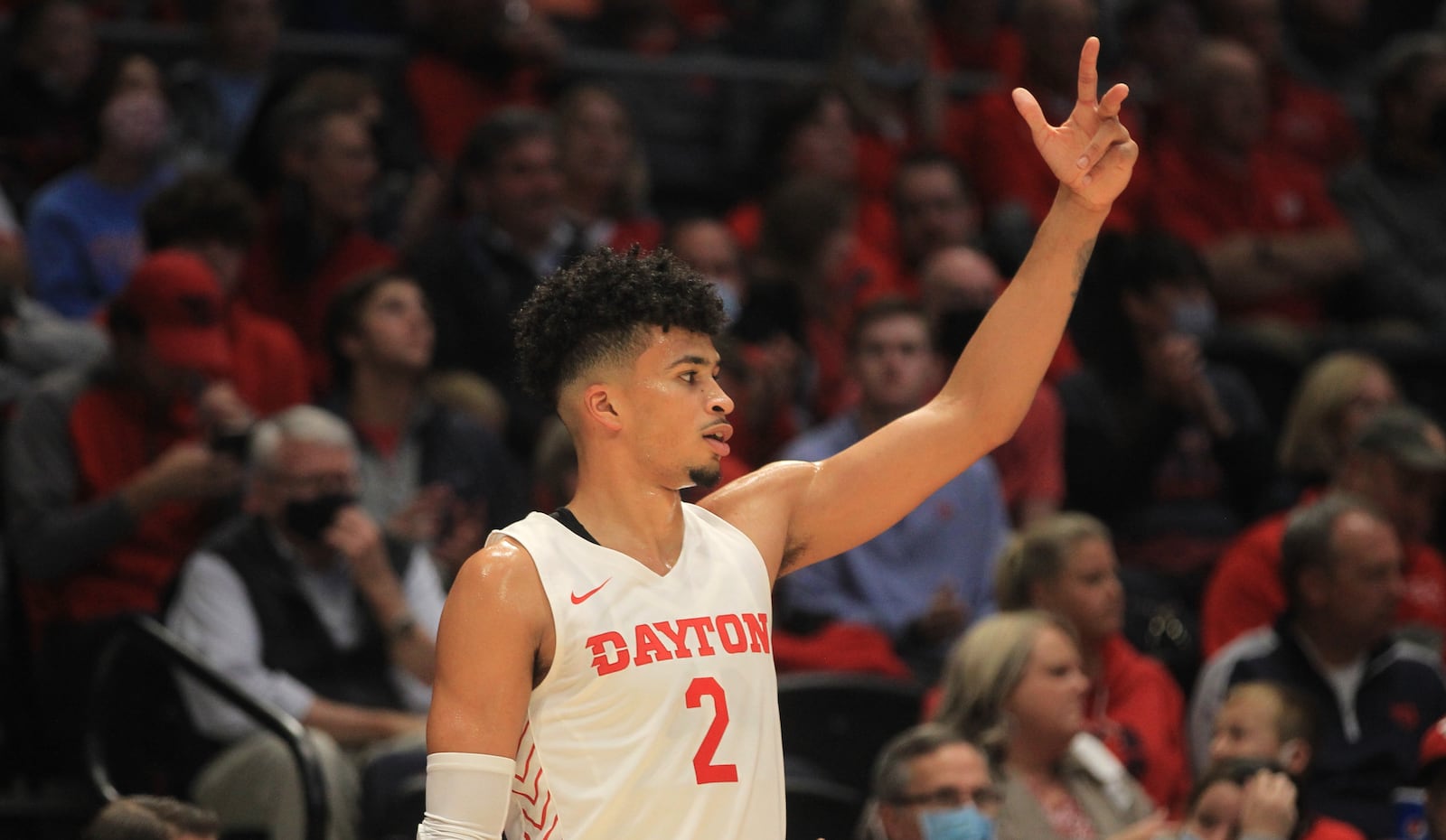 Dayton's Toumani Camara holds up three fingers after a 3-pointer by a teammate against Cedarville in an exhibition game on Monday, Nov. 1, 2021, at UD Arena. David Jablonski/Staff