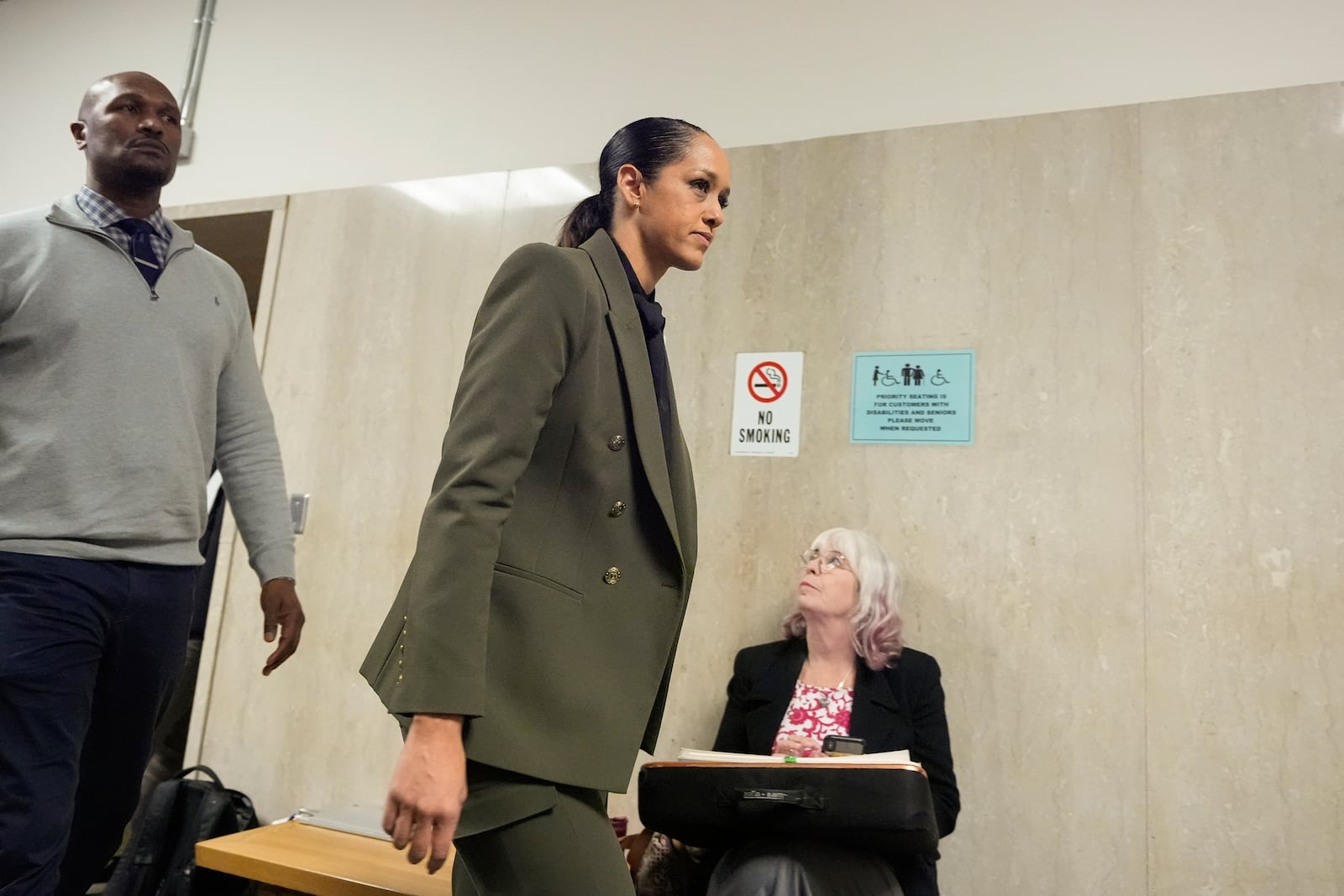 San Francisco district attorney Brooke Jenkins, second from left, walks out of the courtroom at the Hall of Justice for the murder trial of Nima Momeni, Monday, Dec. 2, 2024, in San Francisco. (AP Photo/Godofredo A. Vásquez)