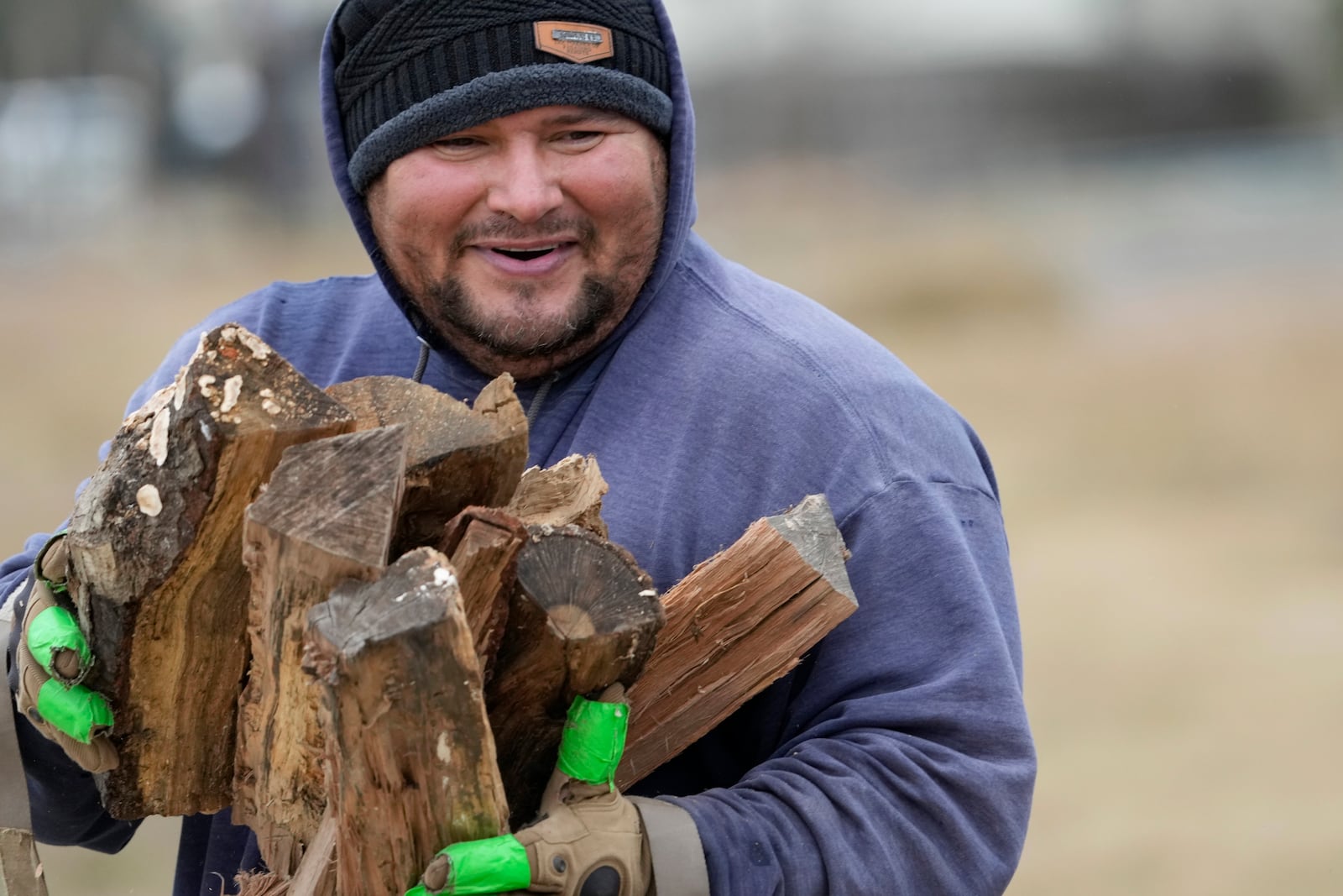 William Amaya gathers firewood for a customer Monday, Jan. 20, 2025, in Houston ahead of a winter storm predicted to dump several inches of snow in Southeast Texas. (AP Photo/David J. Phillip)