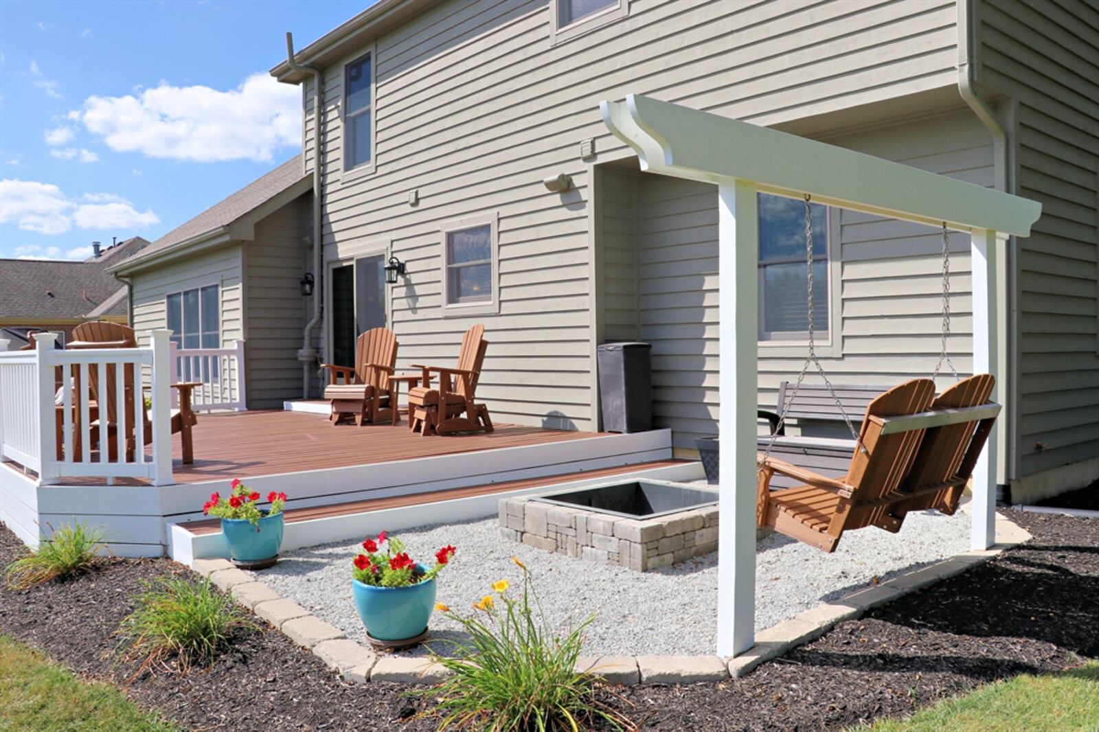 The rear wooden deck was built in 2020; and an extended gravel patio has a fire pit.