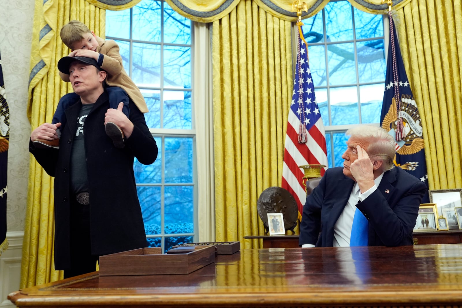 President Donald Trump listens as Elon Musk, joined by his son X Æ A-Xii, speaks in the Oval Office at the White House, Tuesday, Feb. 11, 2025, in Washington. (Photo/Alex Brandon)